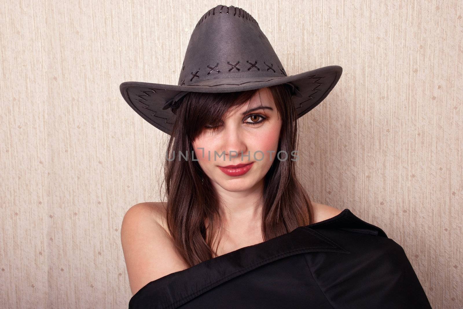 Portrait sexy girl in cowboy hat looking at camera.