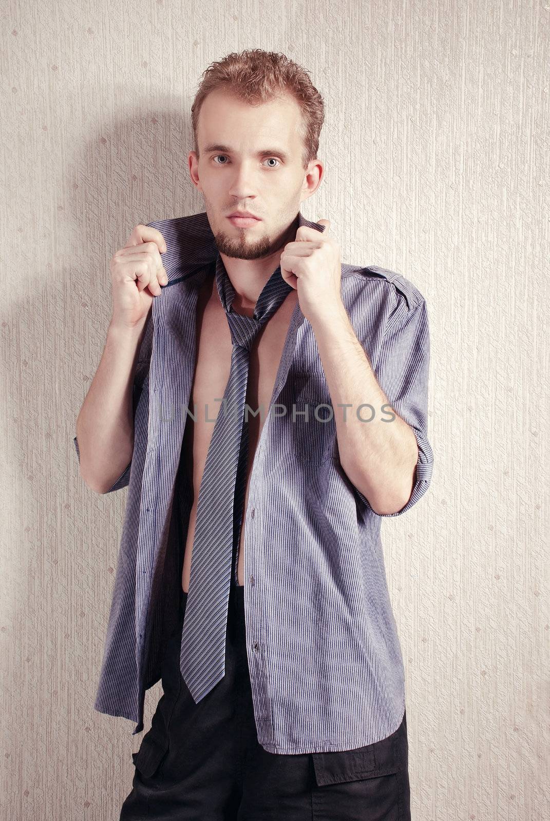 Elegant young handsome man. Fashion studio shot.