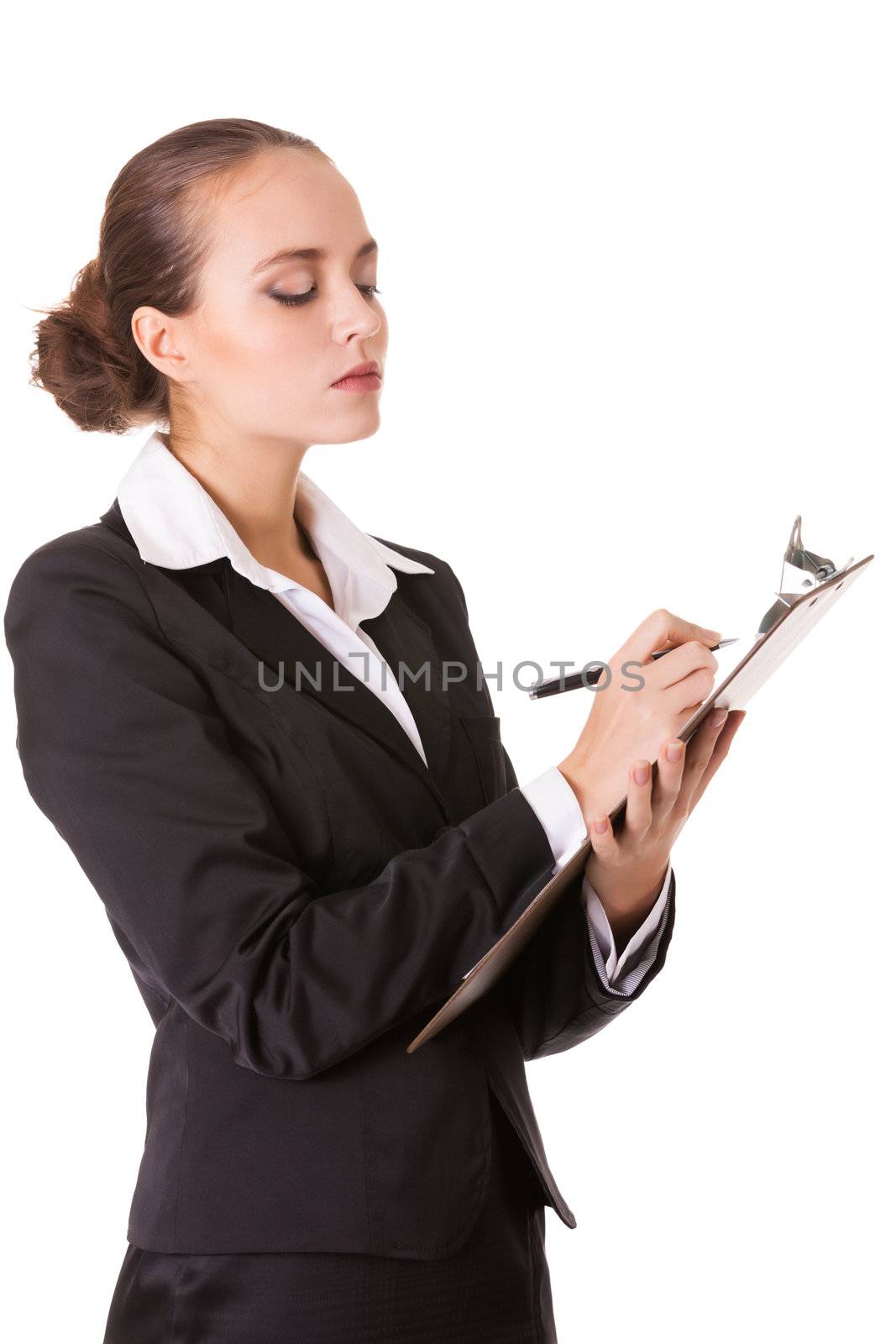 Serious business woman with a clipboard makes notes in document. Isolated on white background.