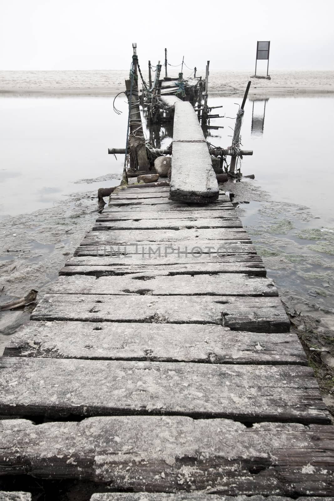 Desolated wooden pier in low saturation