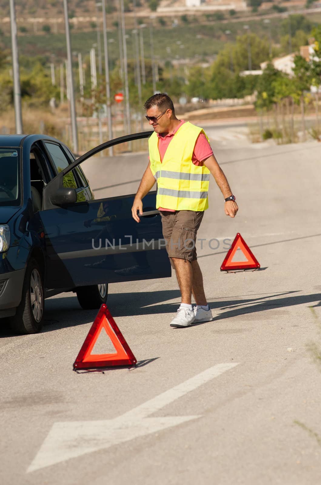 Guy having just broken down on a lonely road