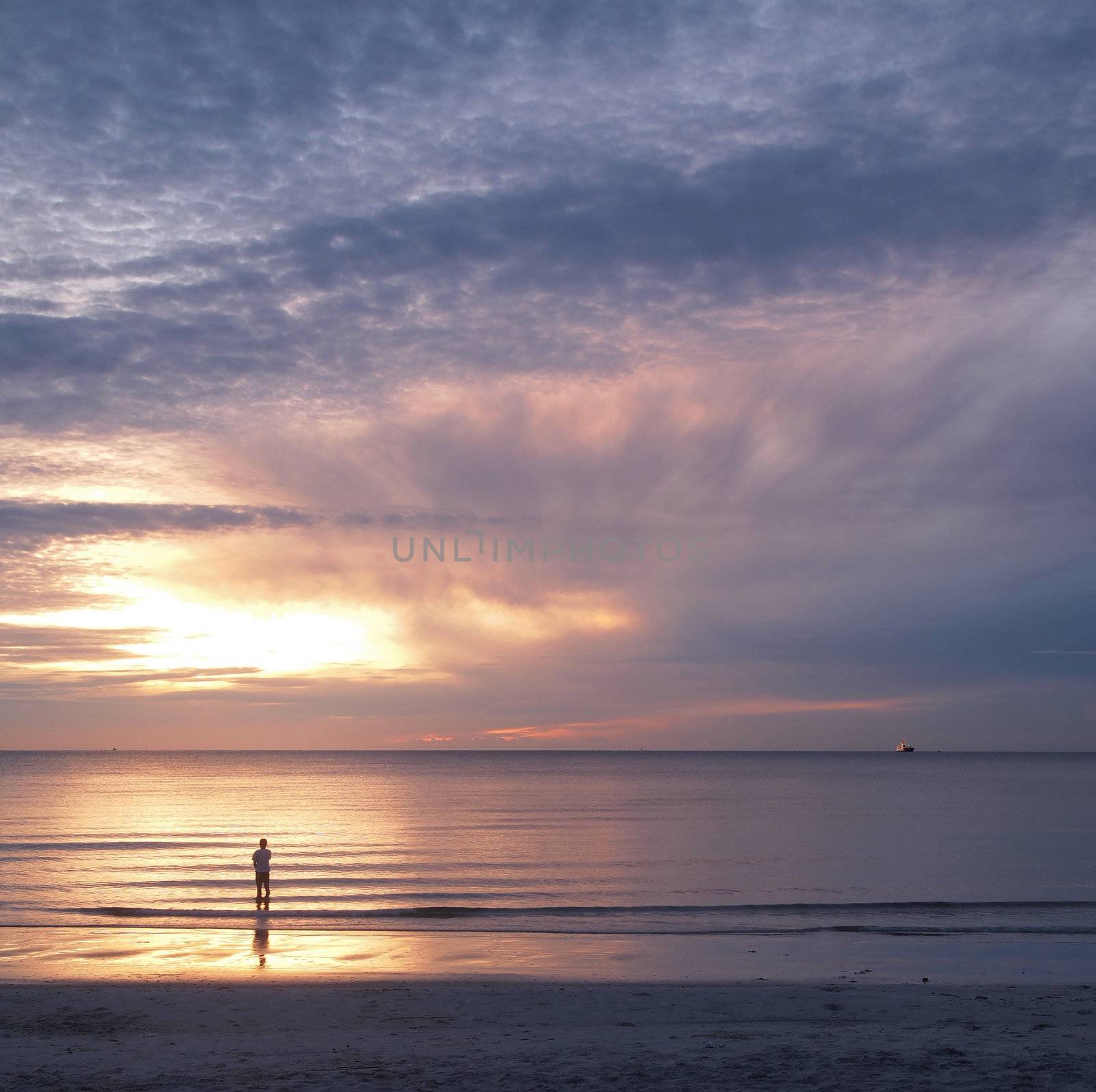 young man and sunset on sea,showing lonely concept.