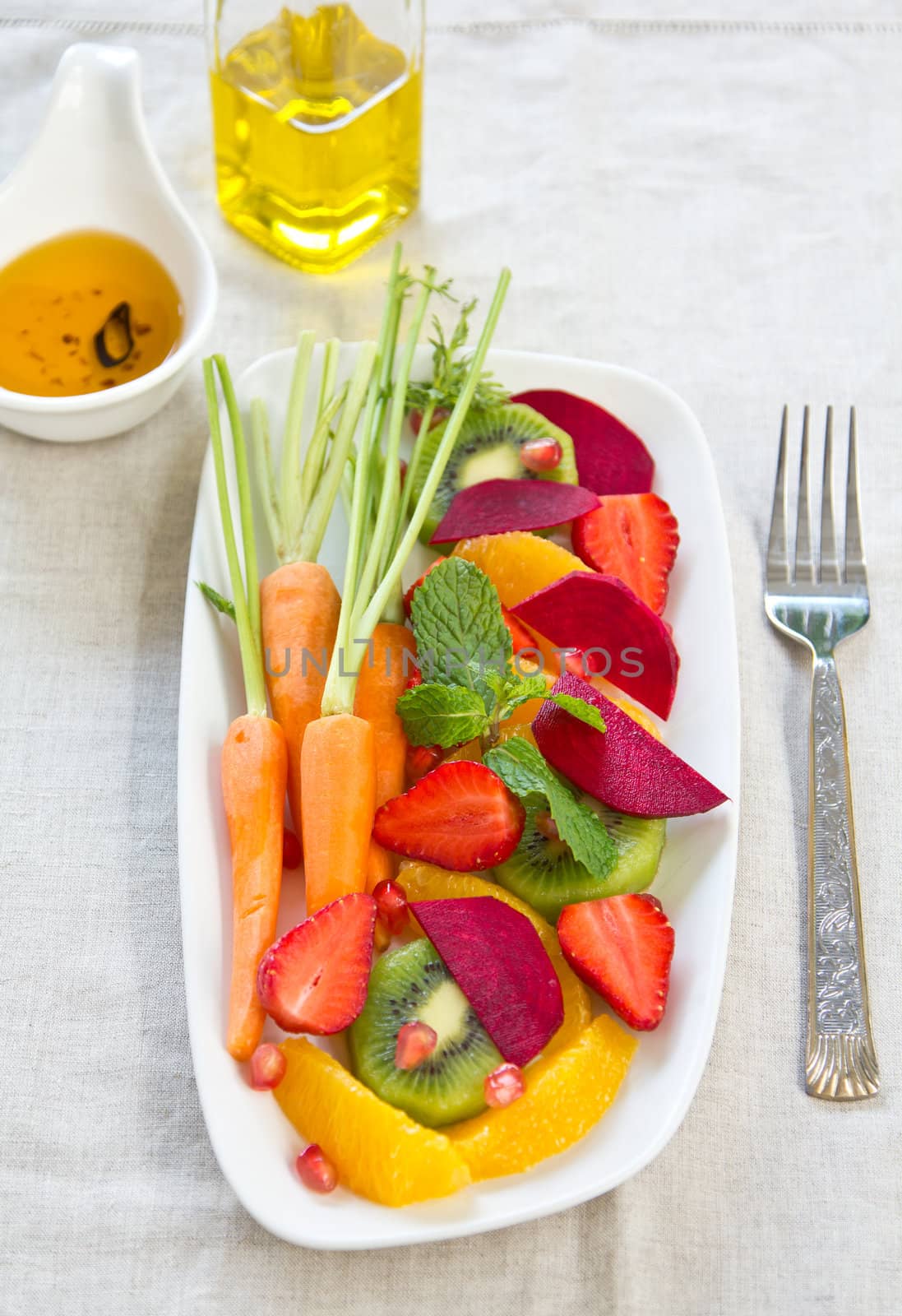 Fresh orange,kiwi,strawberry,pomegranate with baby carrot and beetroot salad by chilli oil