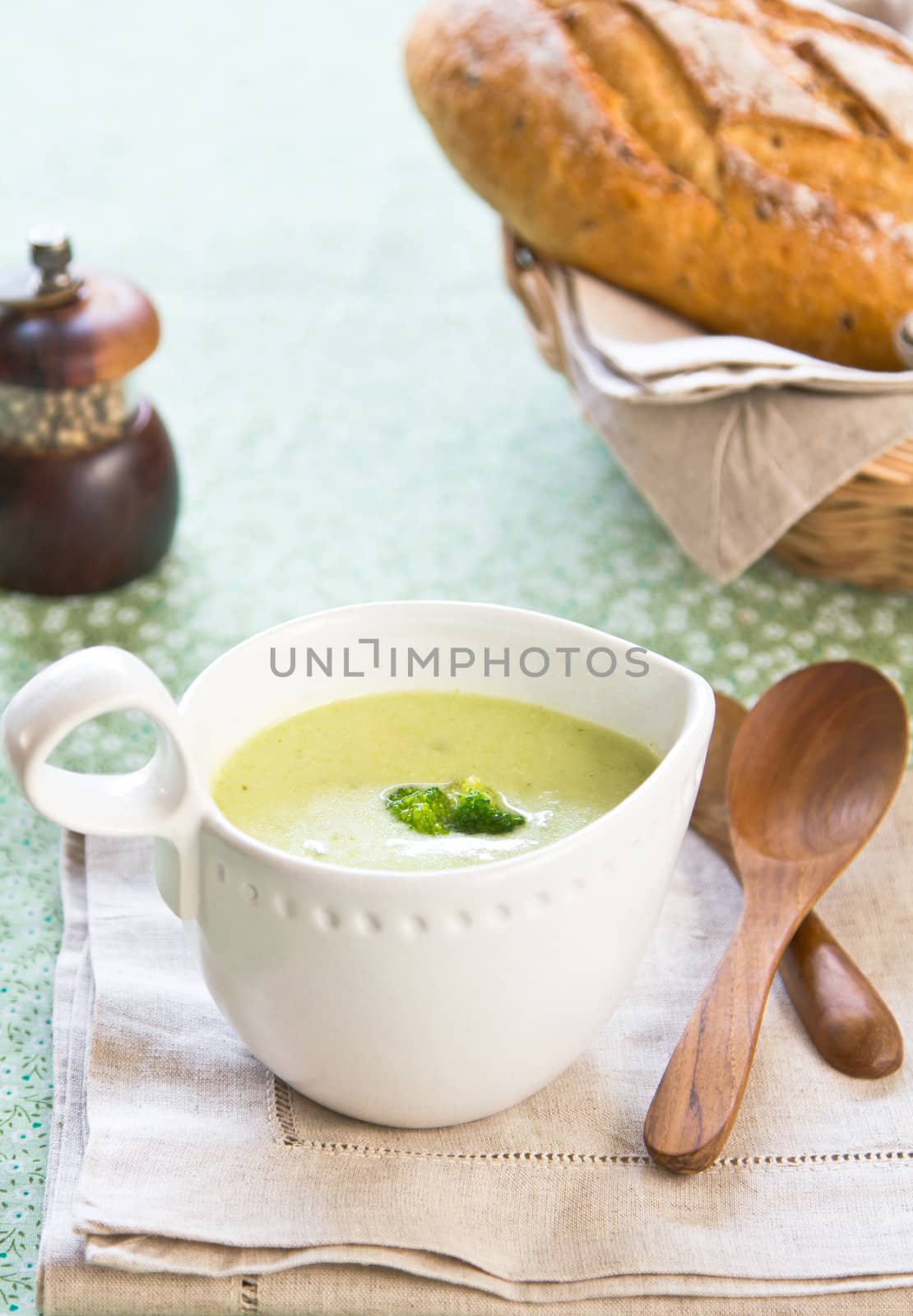 Broccoli soup by a loaf of wholemeal bread