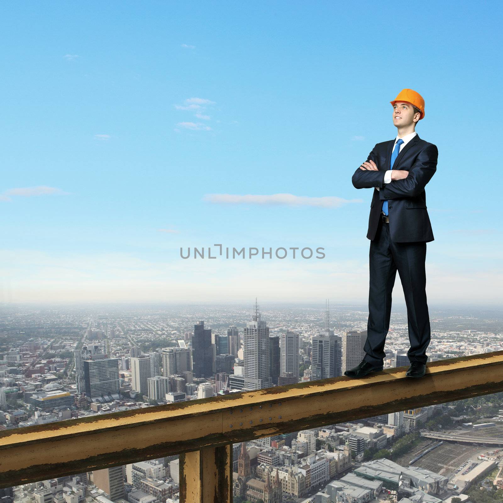 Businessman standing on the construction site by sergey_nivens