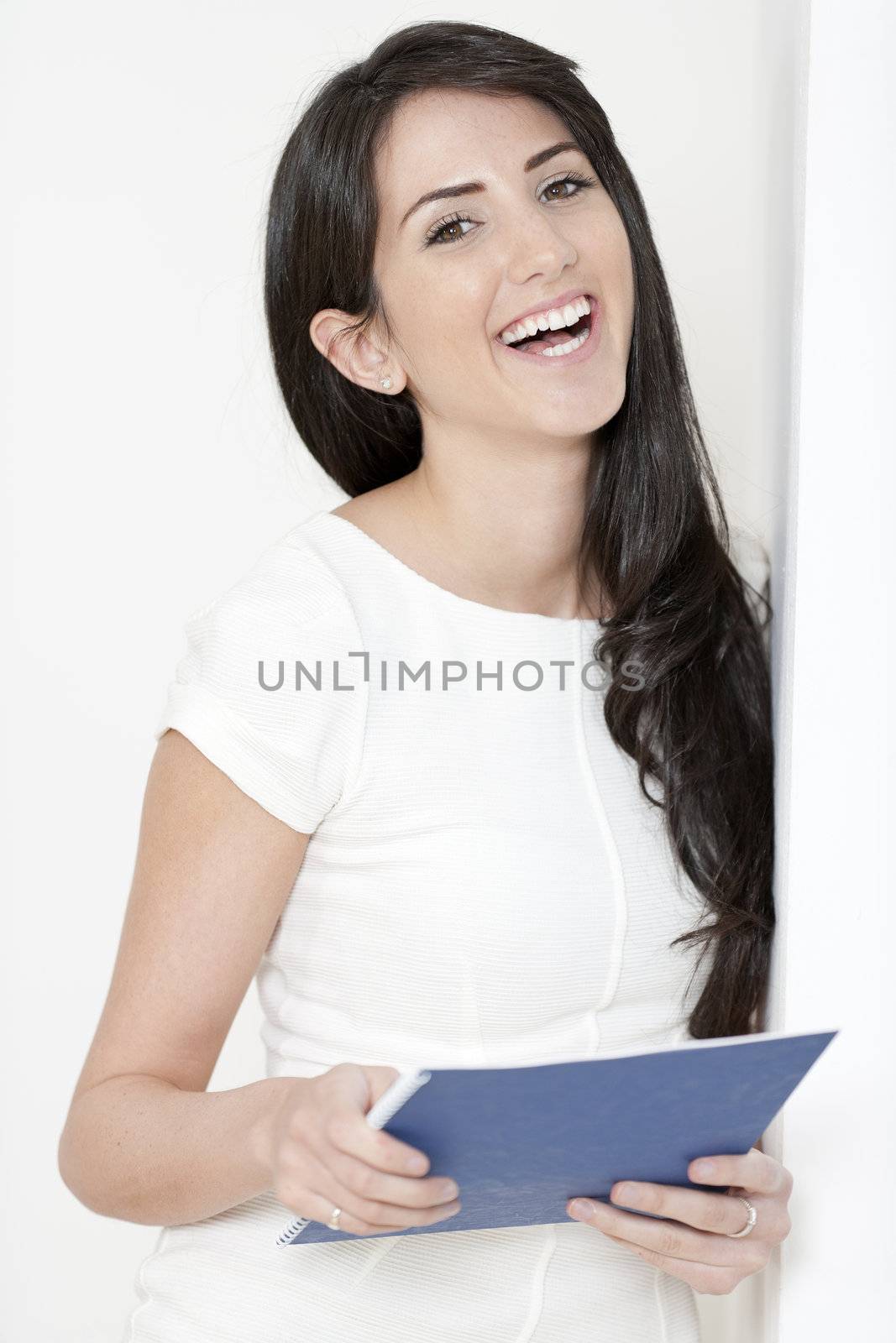 Woman with white dress holding documents by studiofi