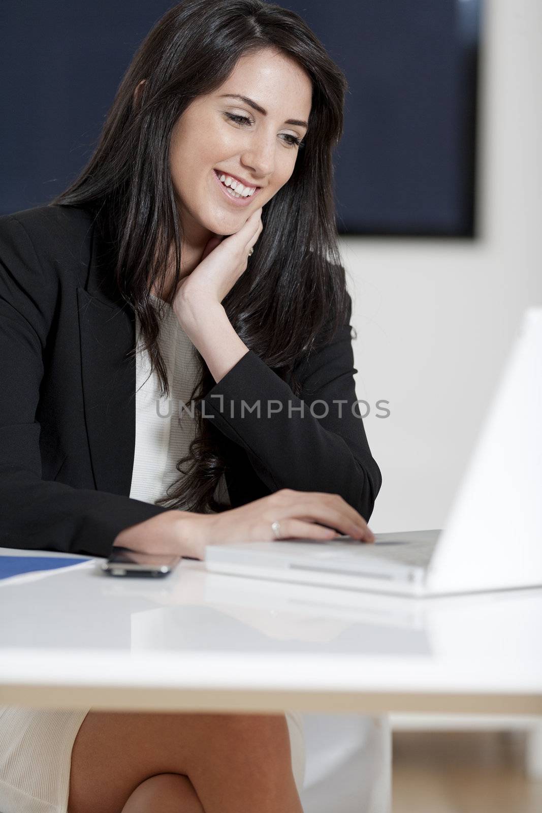 Young woman working at her desk in the office