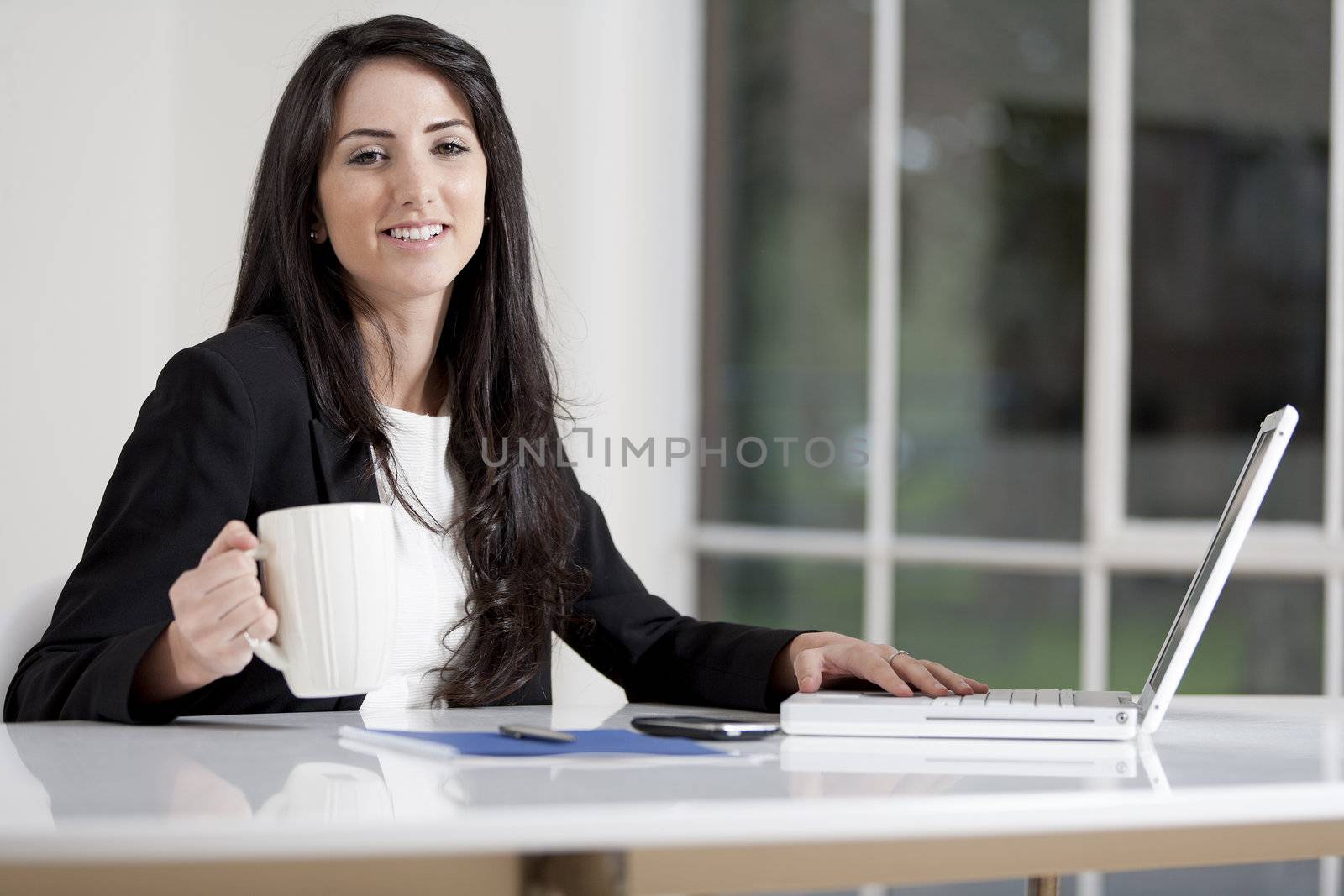 Young woman working at her desk in the office