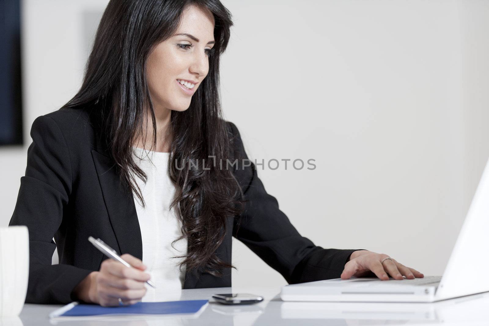 Young woman working at her desk in the office