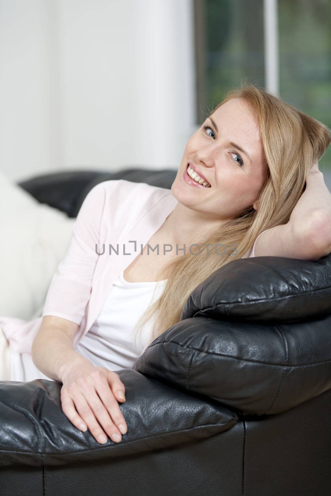Young woman lying on sofa at home