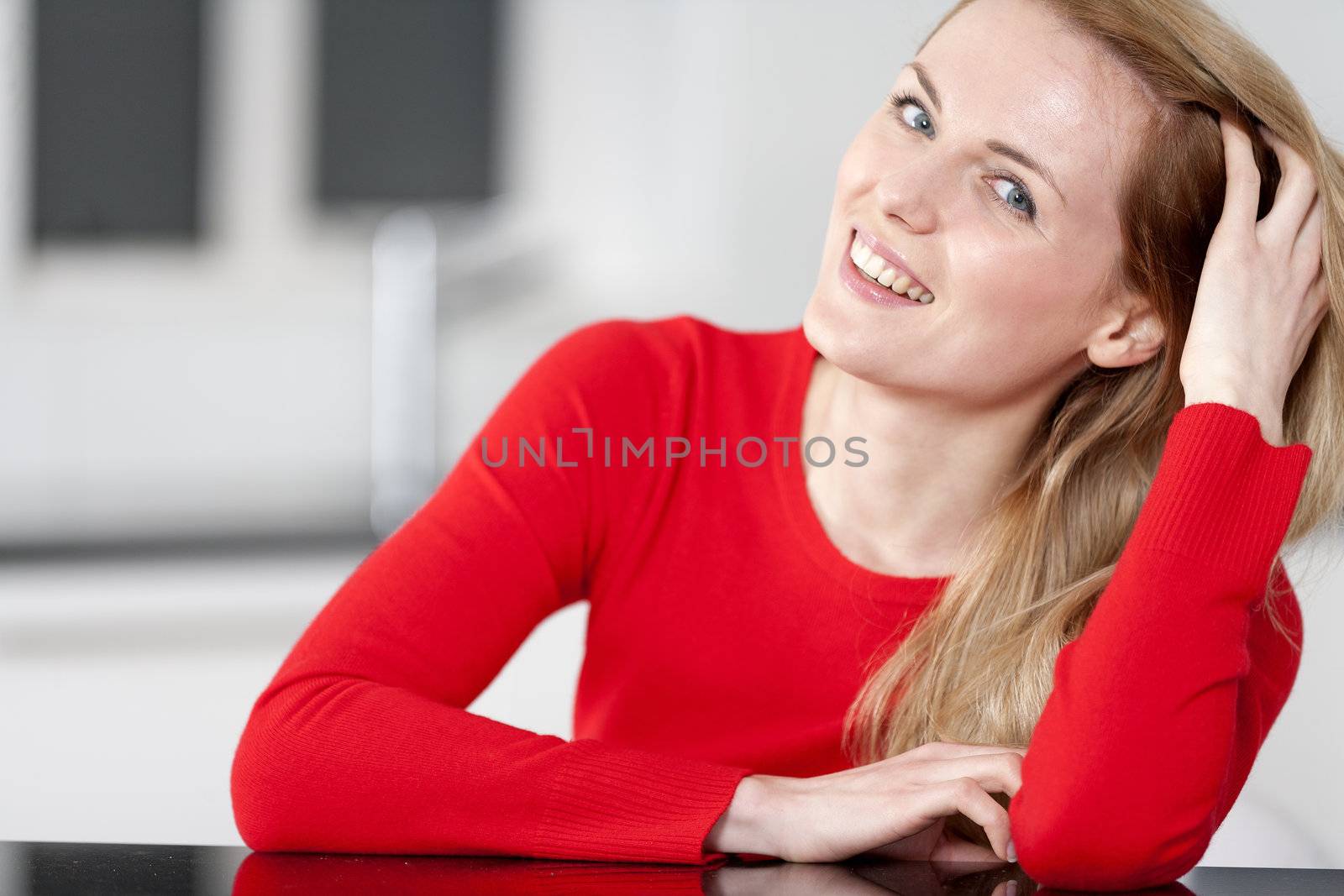 Young woman relaxing in the kitchen at home