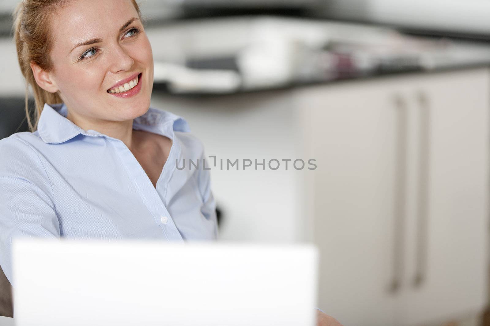 Young woman working at her desk in the office
