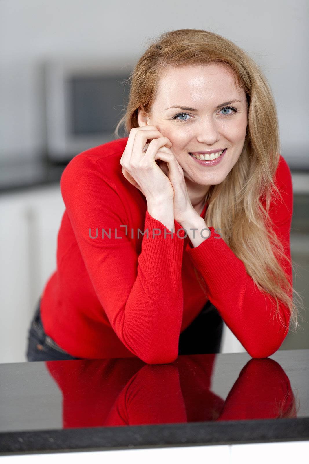 Young woman relaxing in the kitchen at home