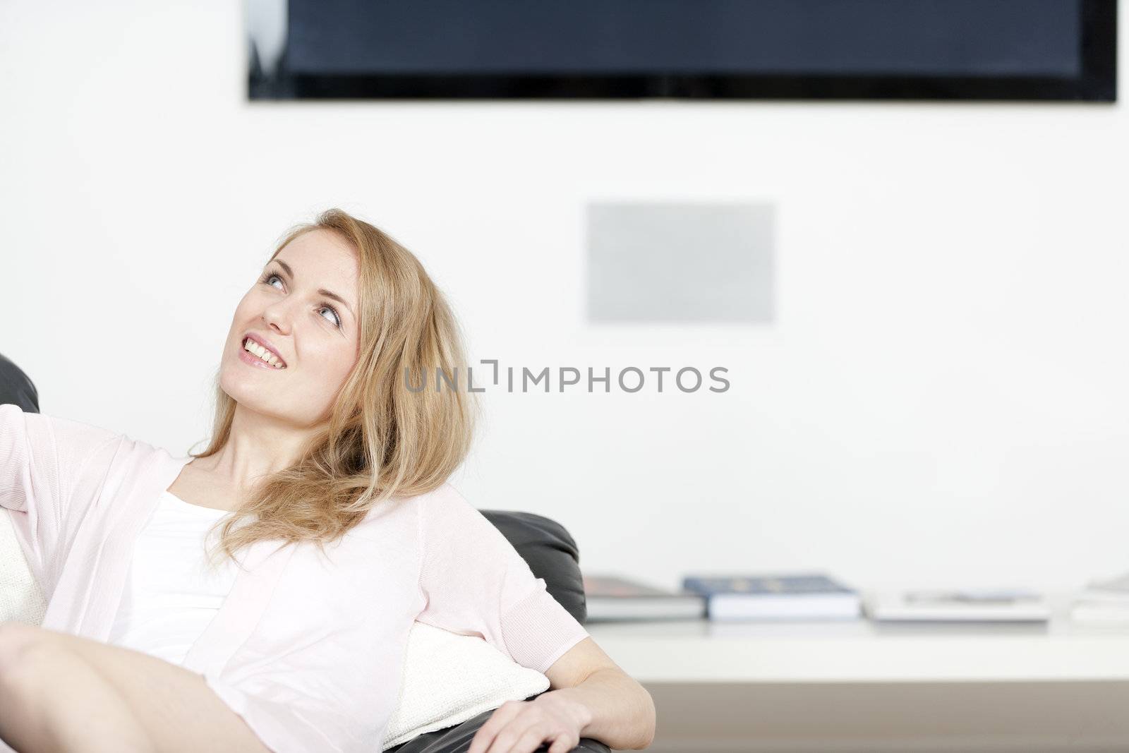 Young woman lying on sofa at home