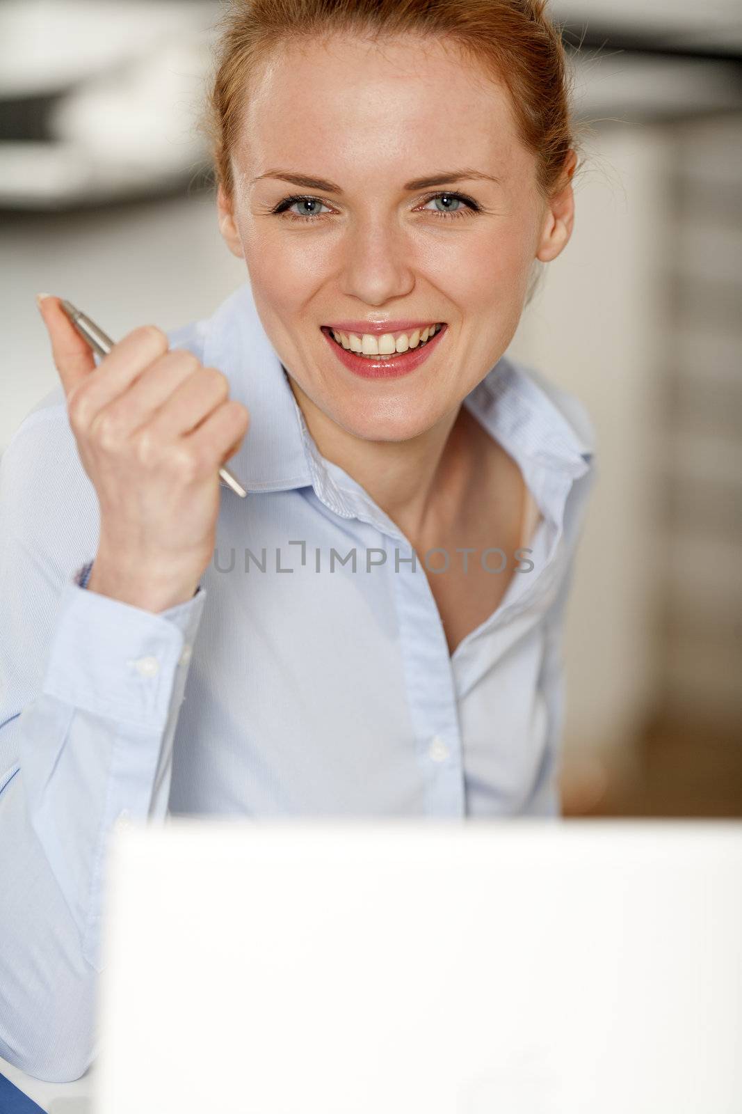 Young woman working at her desk in the office