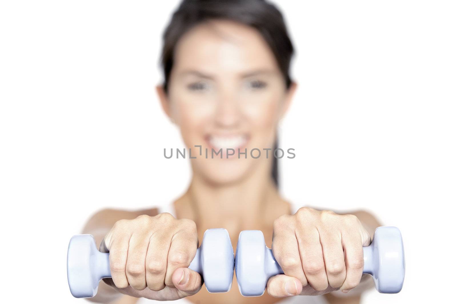 Beautiful young woman training with weights at home