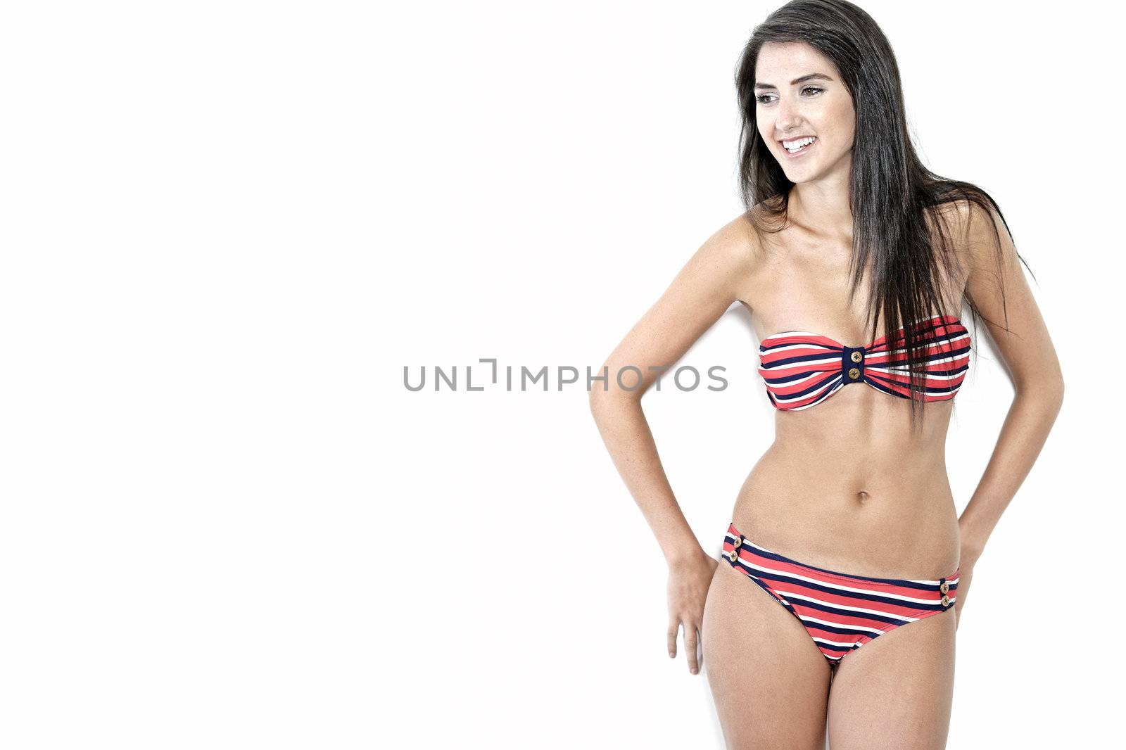 Beautiful sexy woman in red striped bikini smiling and cheerful