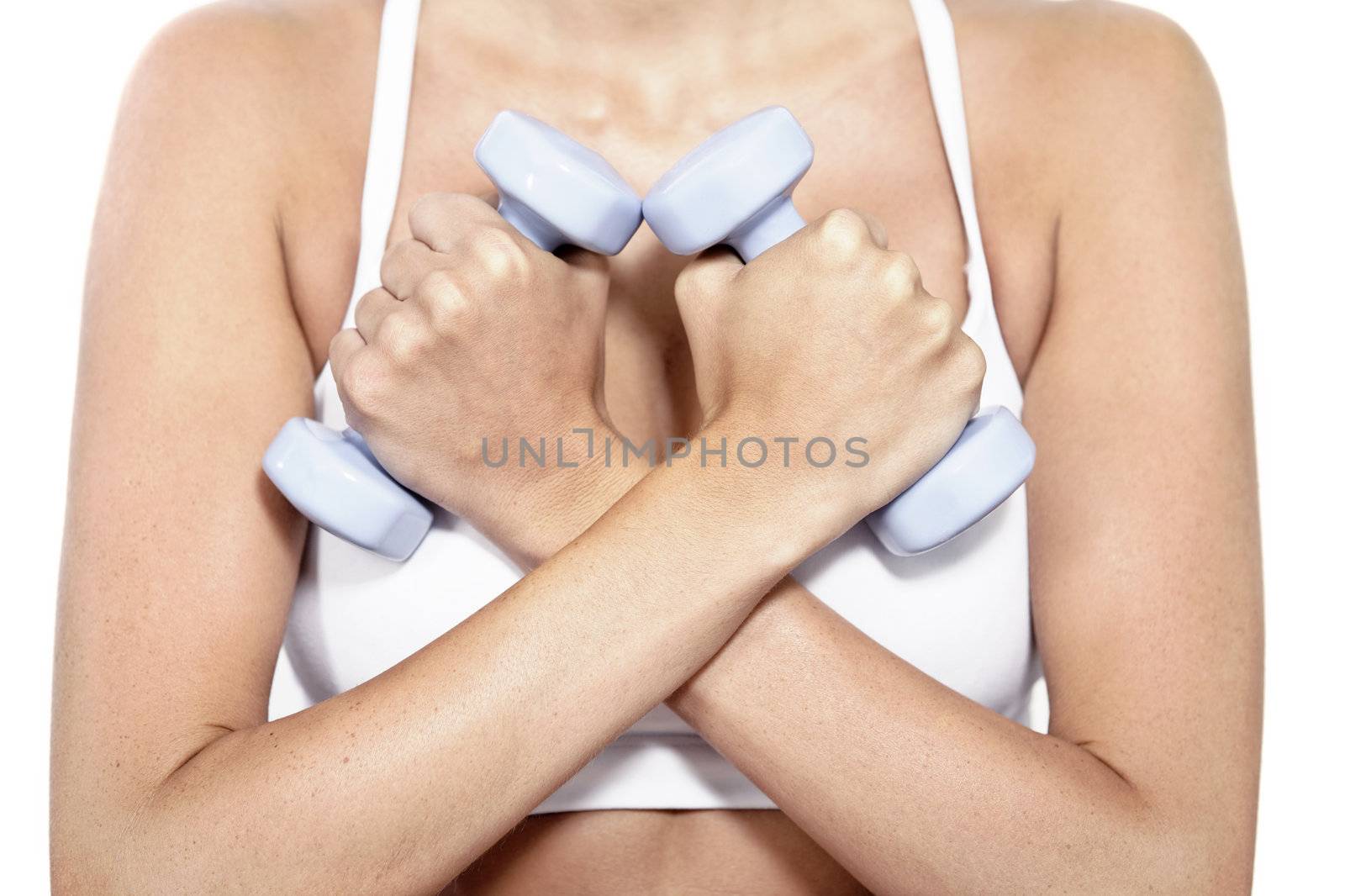 Beautiful young woman training with weights at home