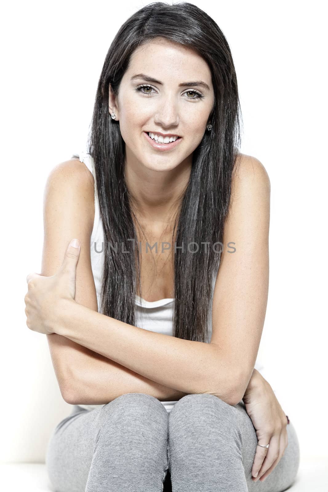 Beautiful young woman in casual clothes resting on white sofa at home