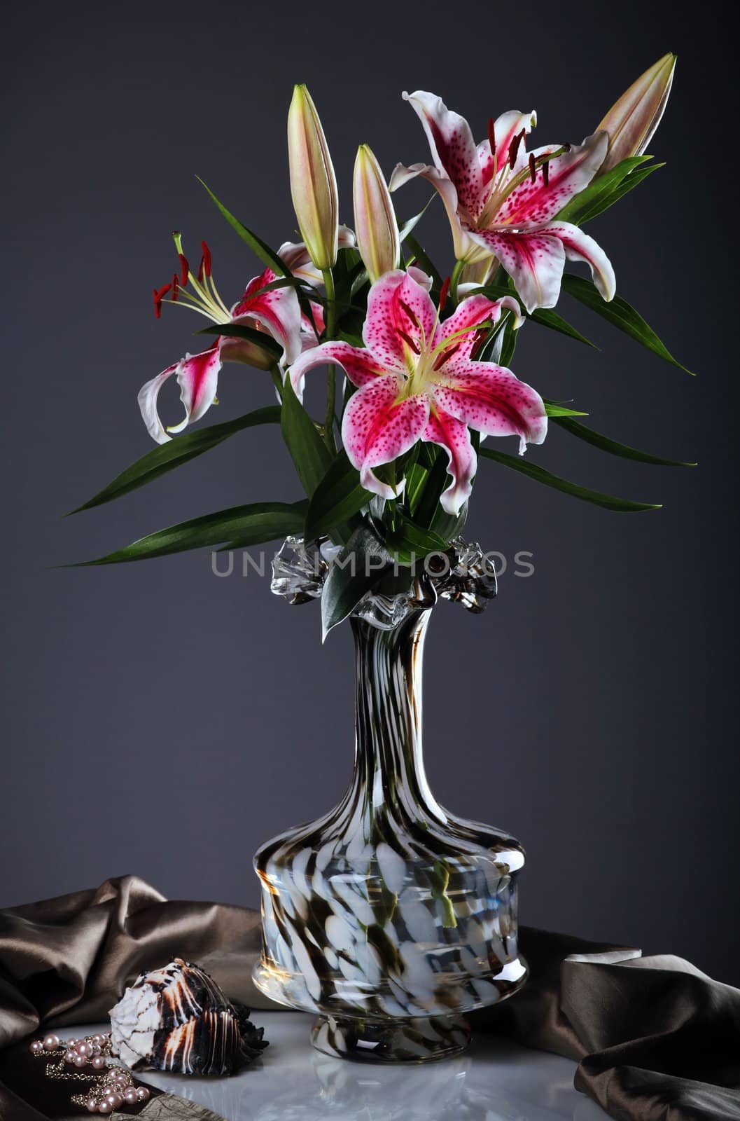 Still life with pink  lily flowers  in a glass vase 