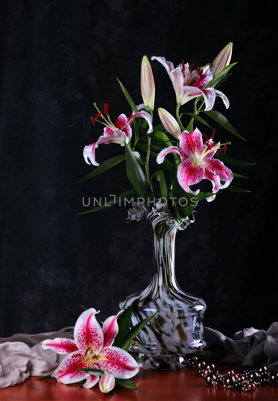 Still life with pink  lily flowers  in a glass vase 