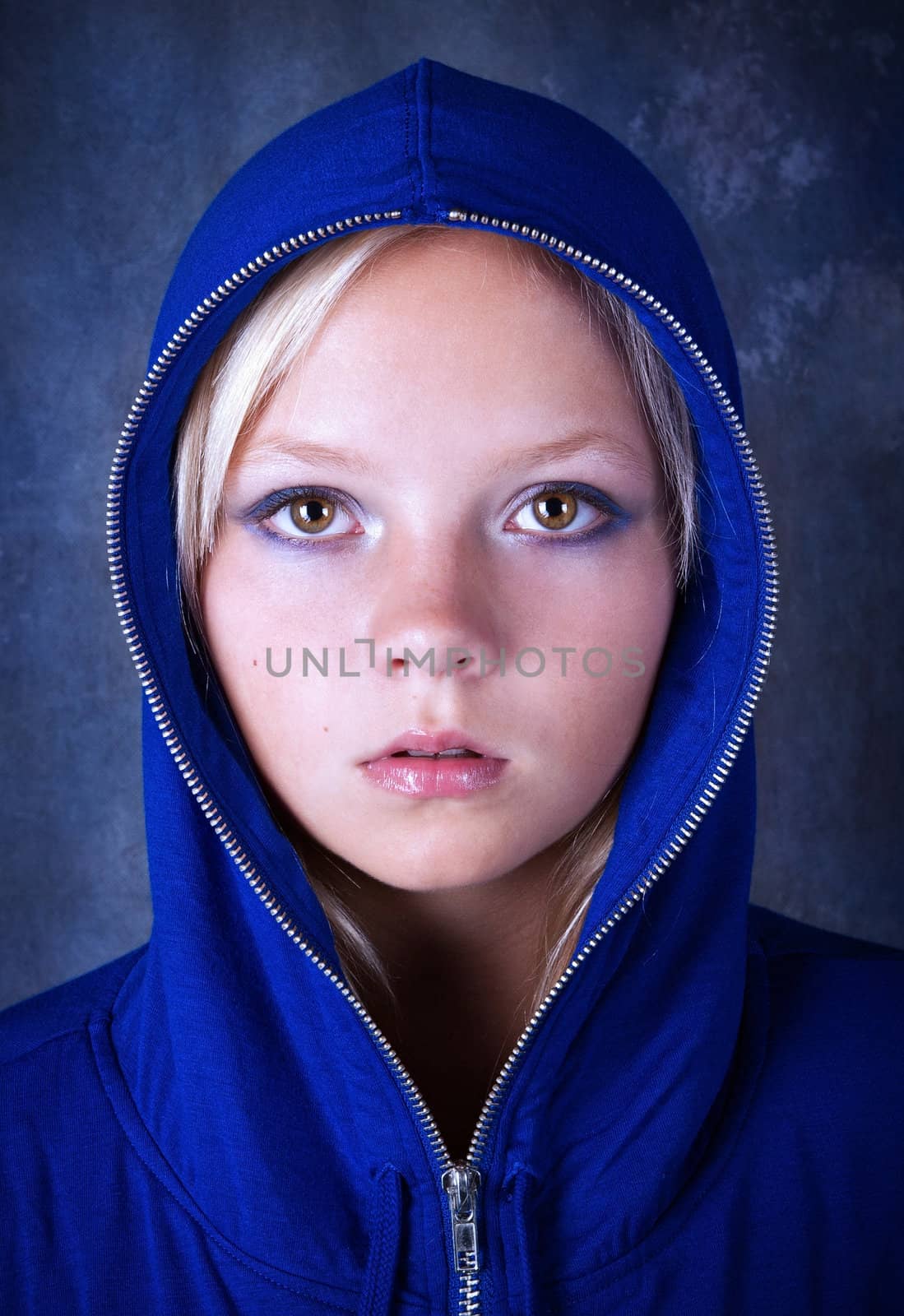 Portrait of young beautiful teen girl in blue hood