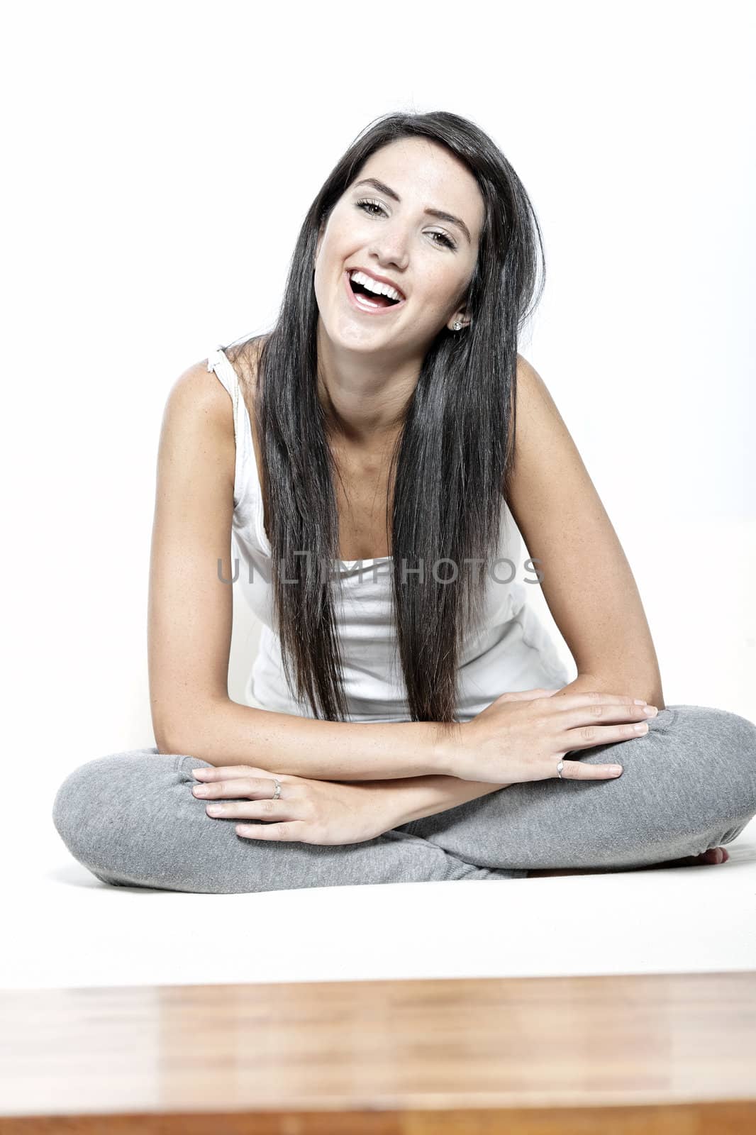 Beautiful young woman in casual clothes resting on white sofa at home