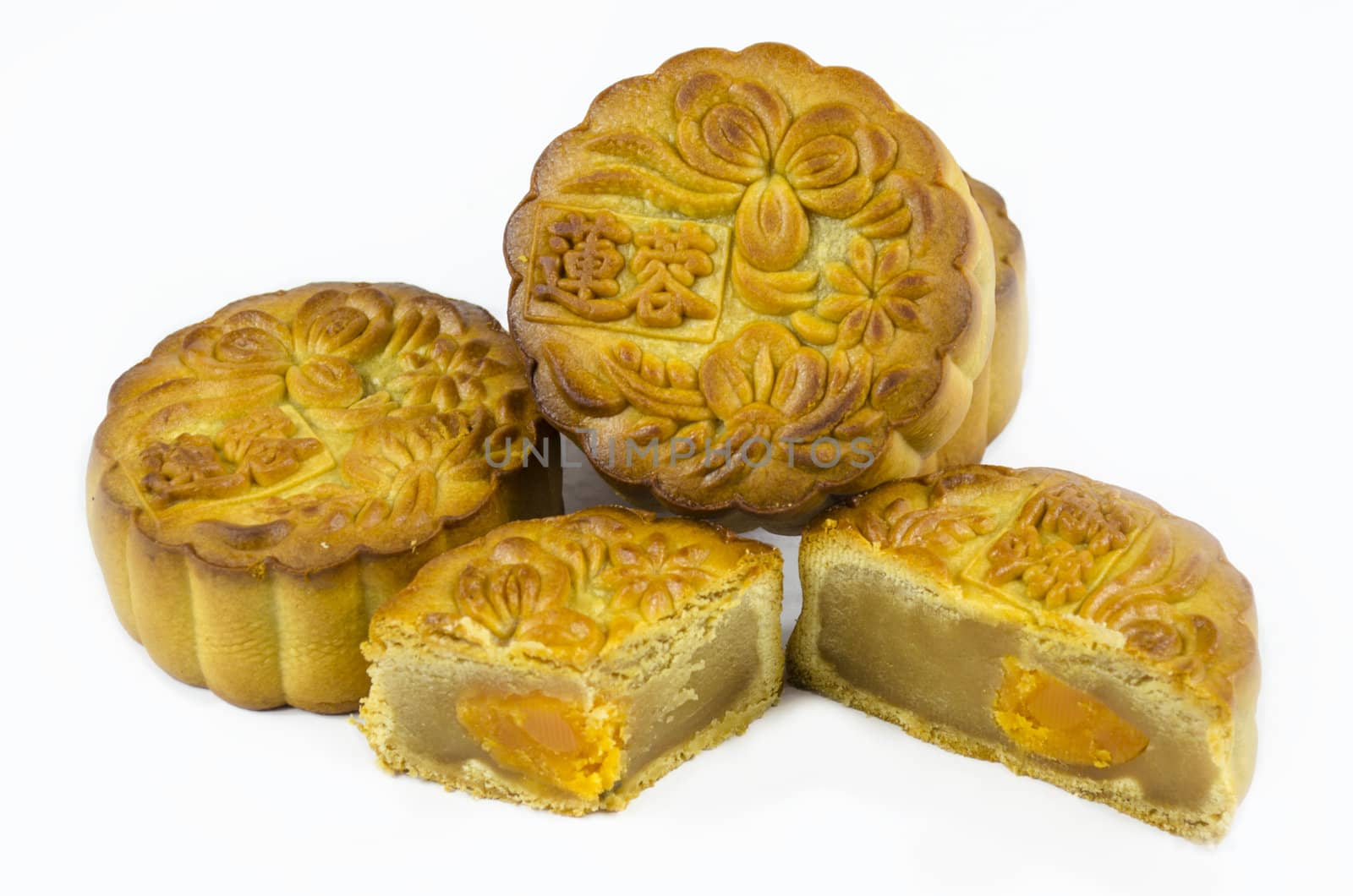 Mooncake cutted with lotus seed paste and yolk inside, isolated white background