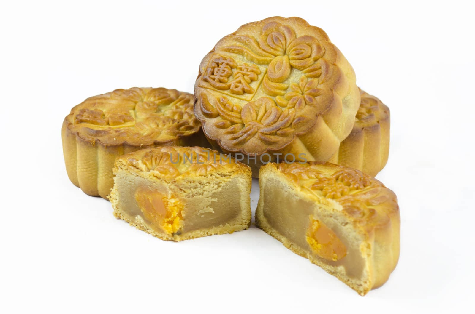 Mooncake cutted with lotus seed paste and yolk inside, isolated white background