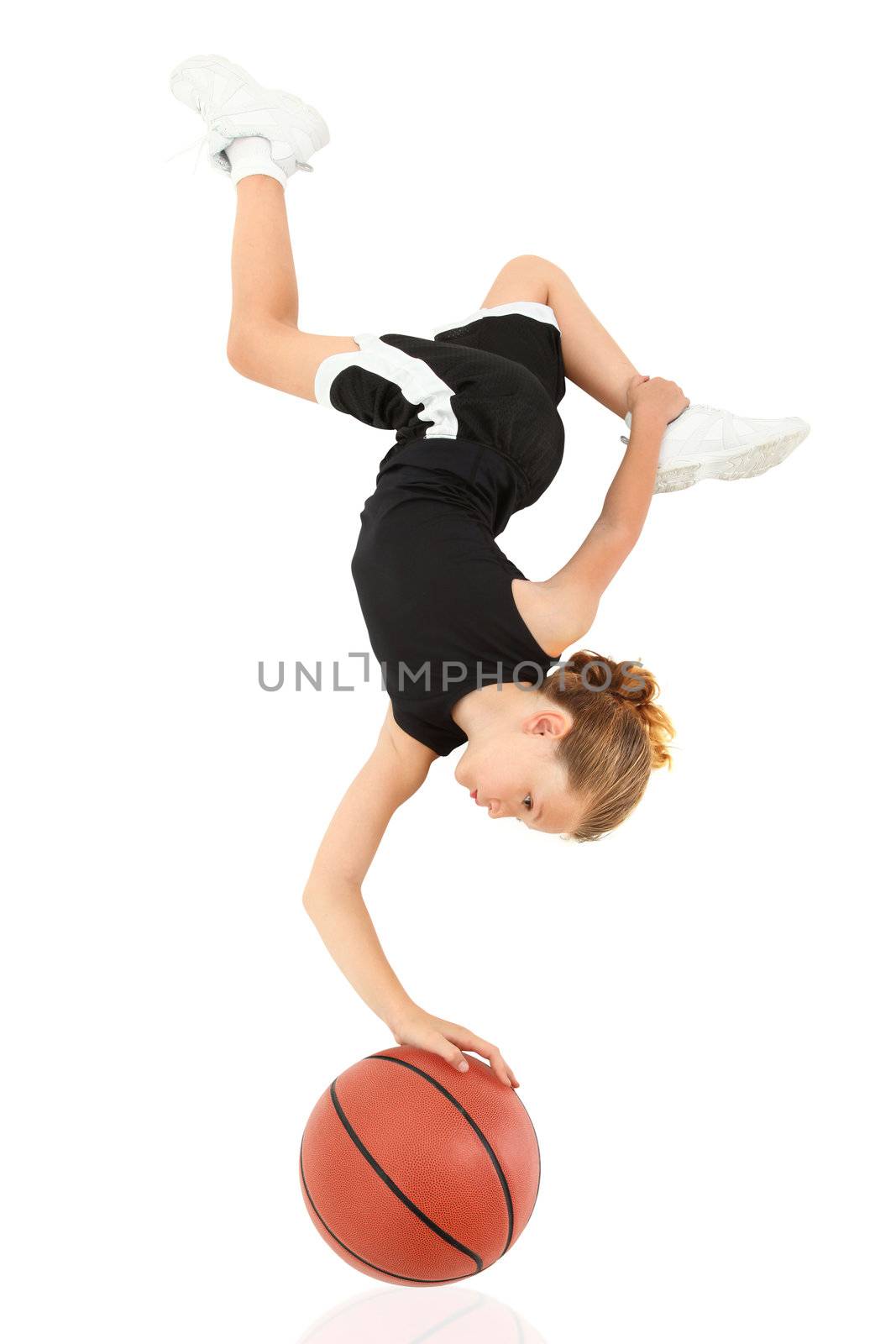Young Girl Child Balancing Upsidedown on Basketball over White by duplass