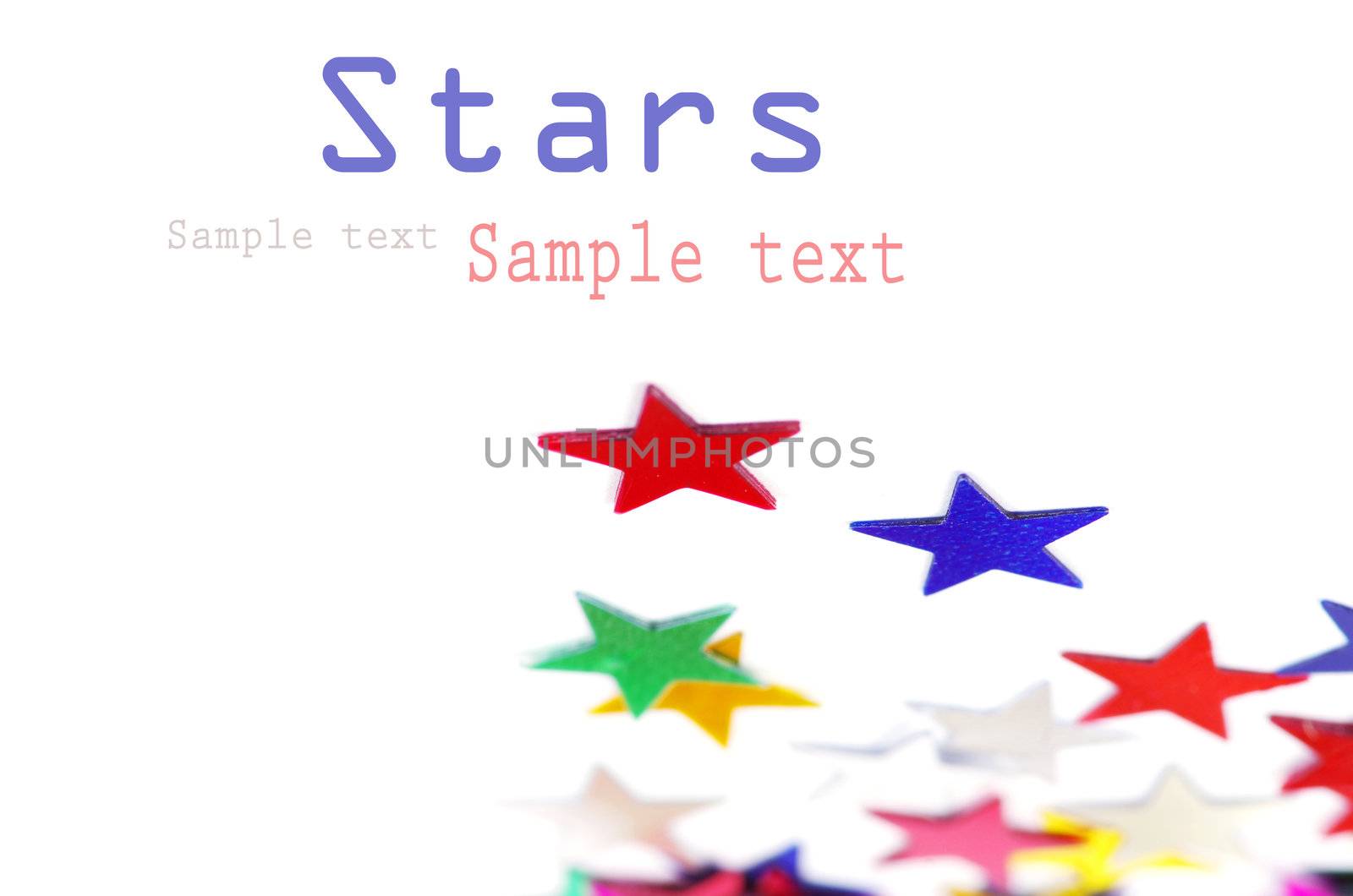 Christmas decoration of colored confetti stars against white background