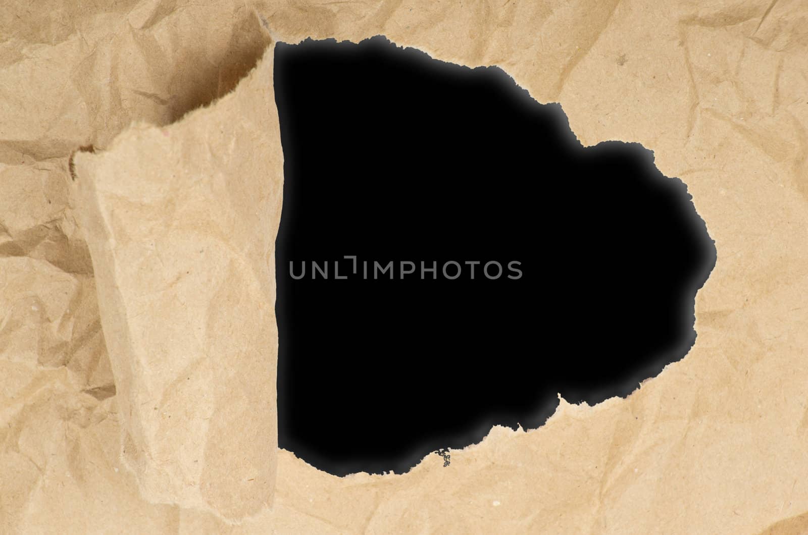 ripped white paper against a black background