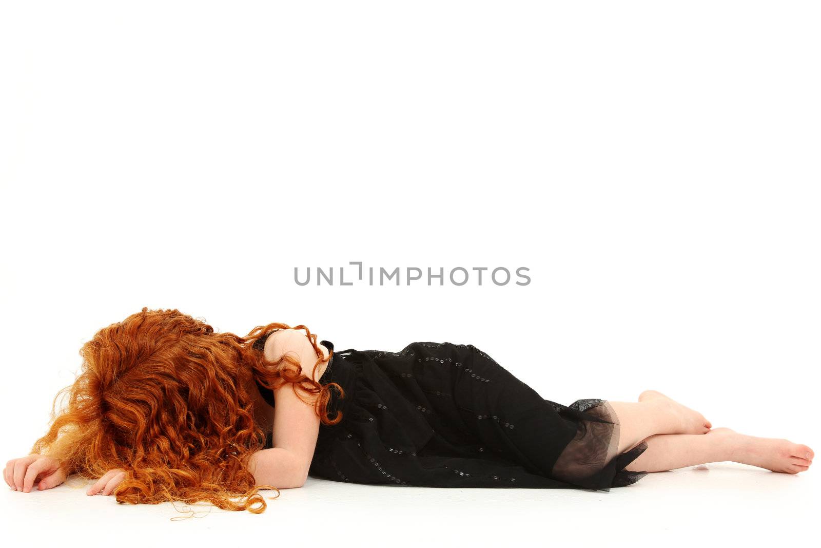 Young elementary girl child laying on floor crying. No face.