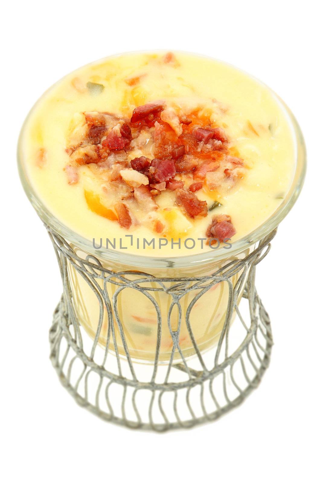 Decorative bowl of Irish Potato Soup with bacon and cheddar. Over white background.