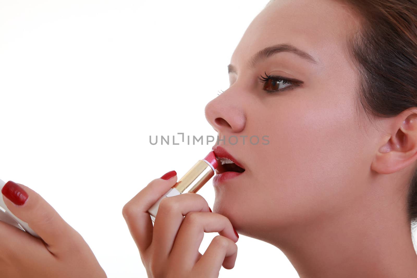 Young woman applying lipstick by shamtor