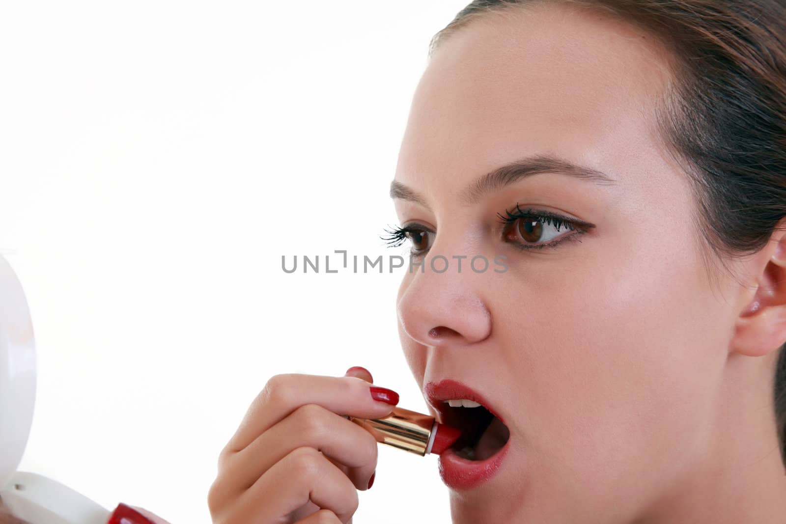 Young woman applying lipstick by shamtor
