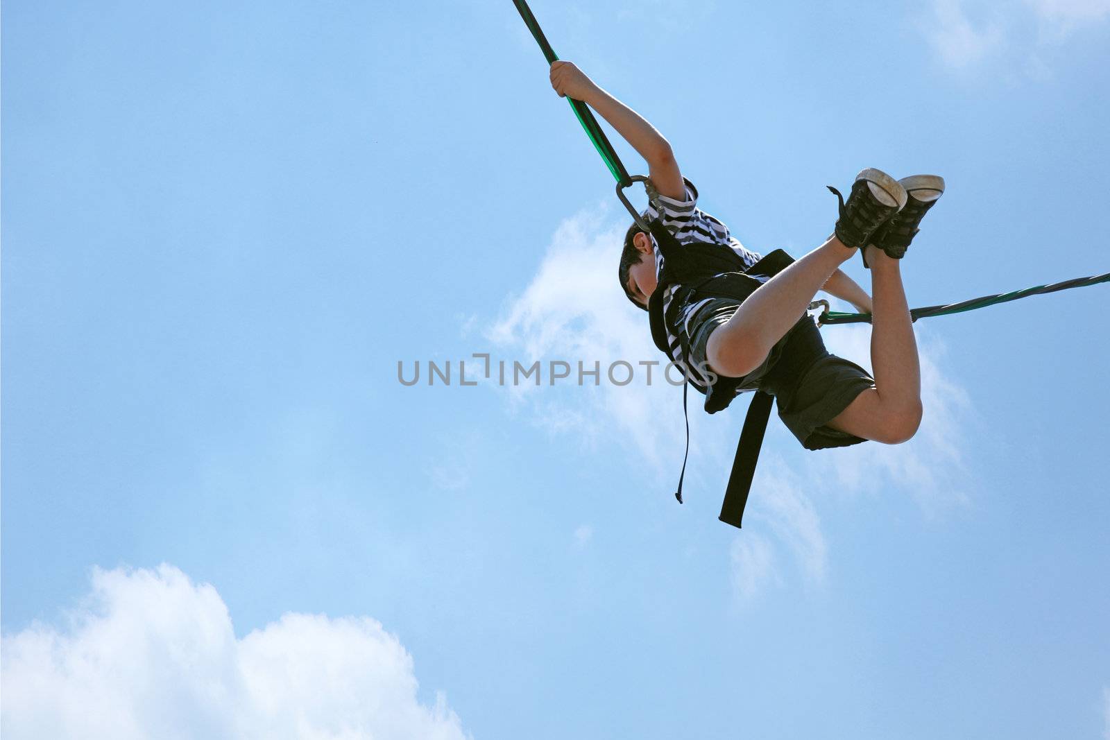 Bungee Jumping Boy Against Blue Cloud Sky with Clipping Path by duplass