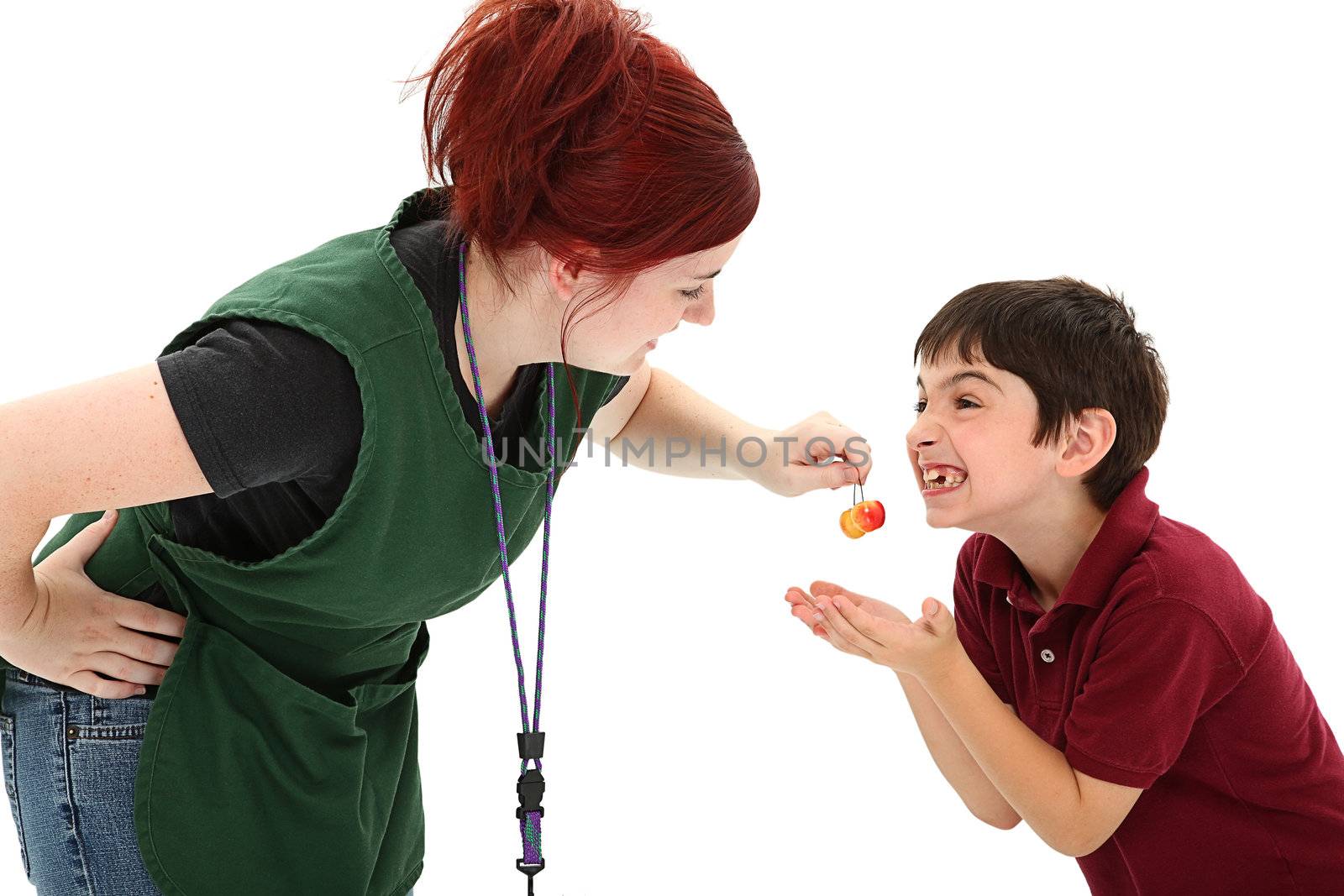 Attractive Grocery Clerk Sharing Cherries with Boy Customer by duplass