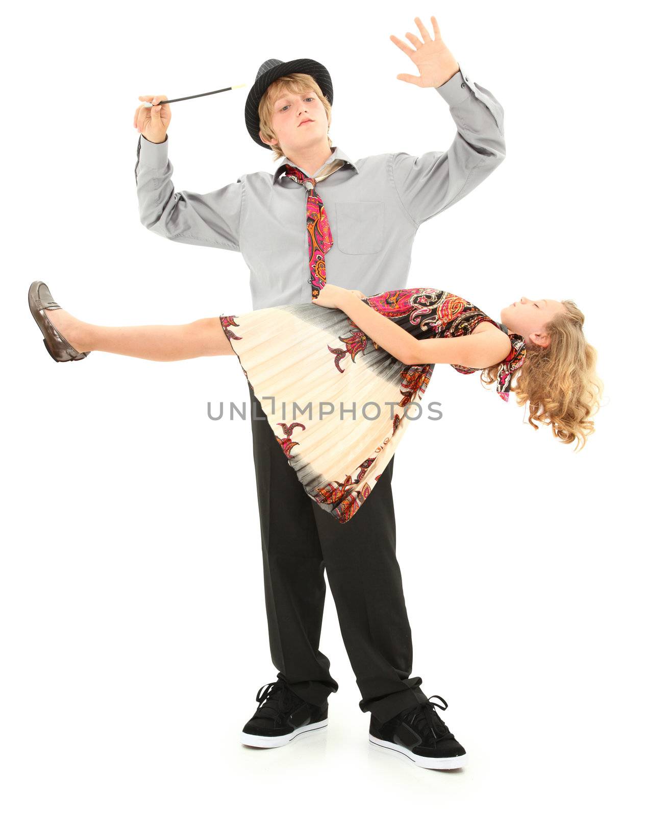 Attractive teen boy and younger sister performing magic show.  Child school talent show act over white.