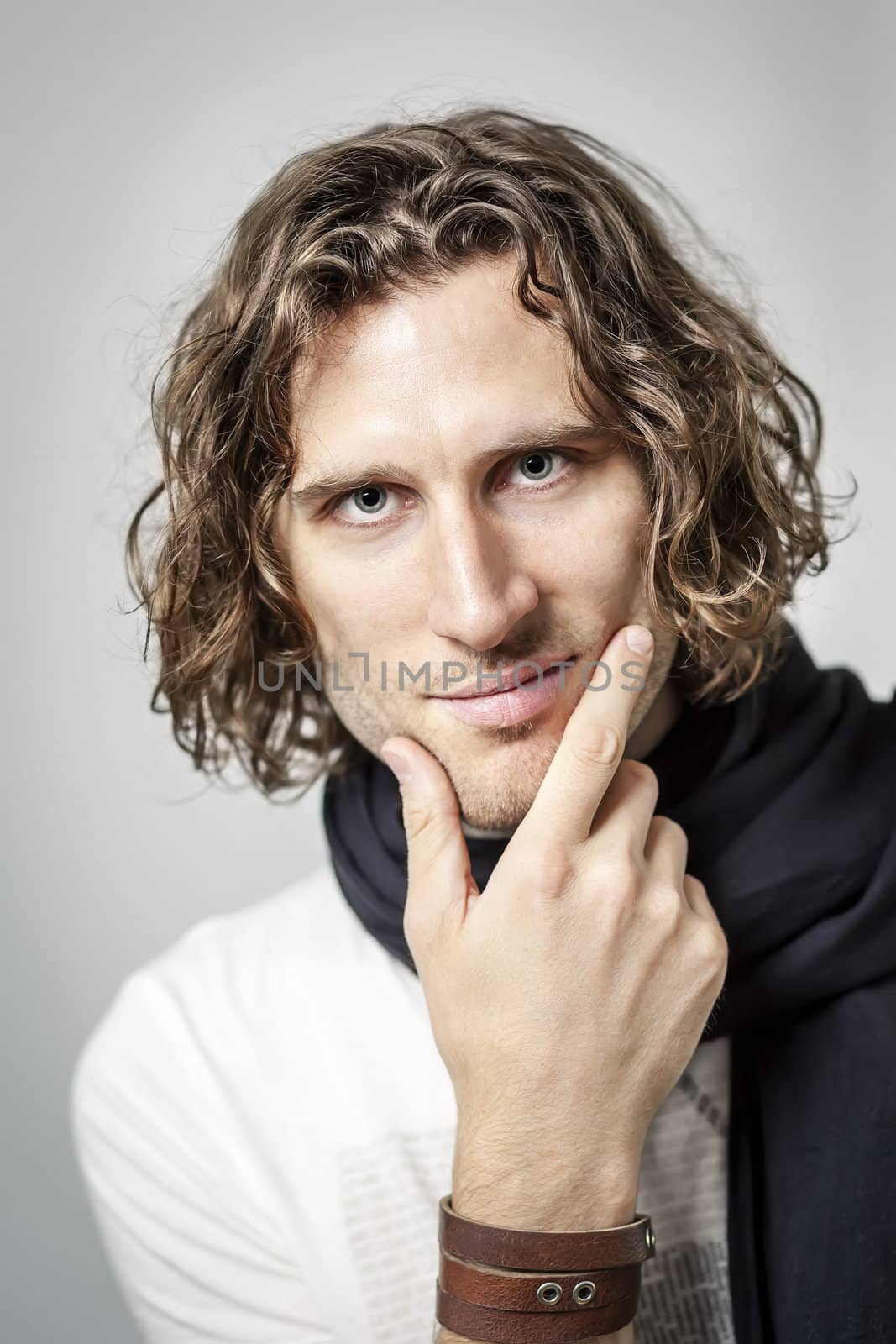 An image of a handsome man with a curly hairdo