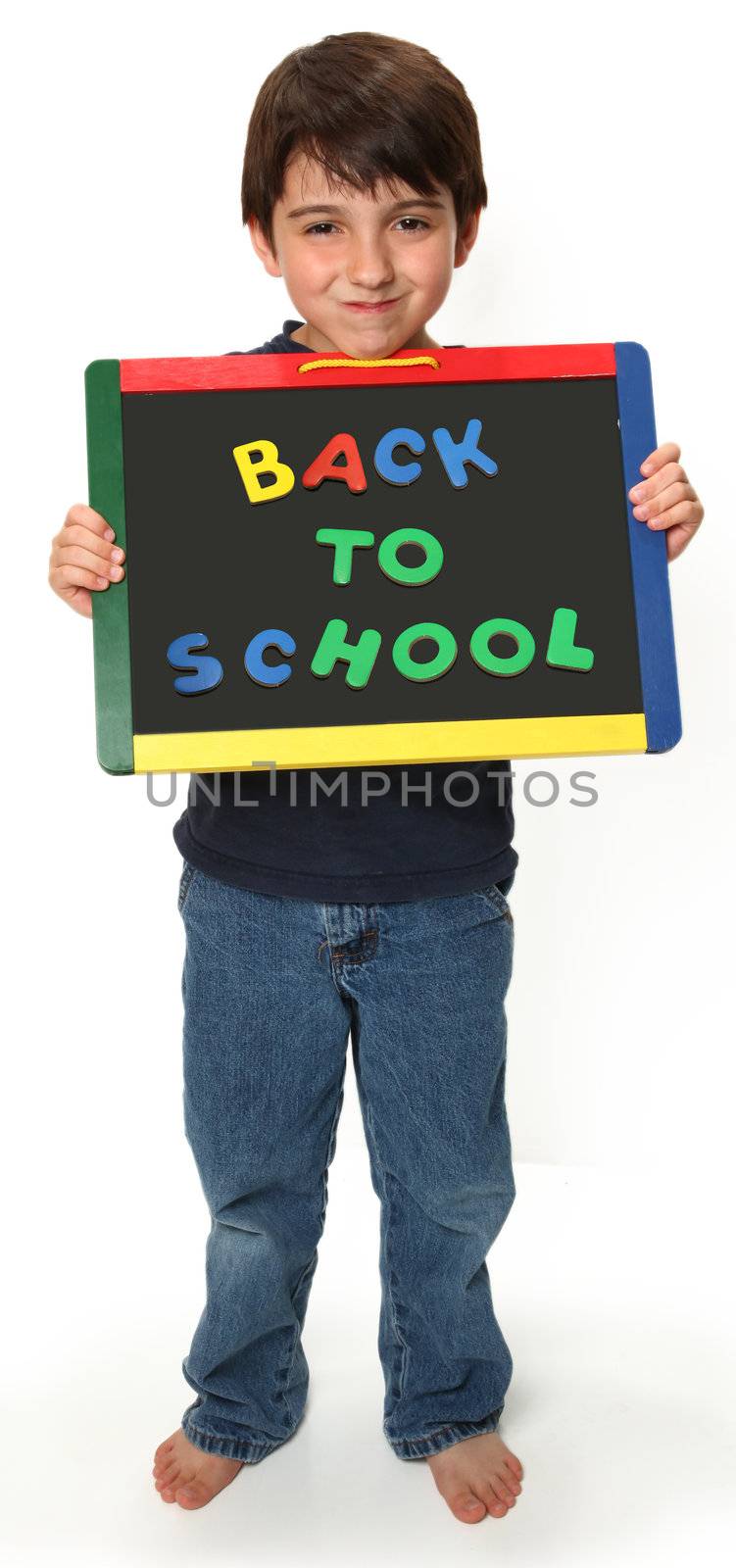 adorable seven year old boy holding back to school magnetic chalk board