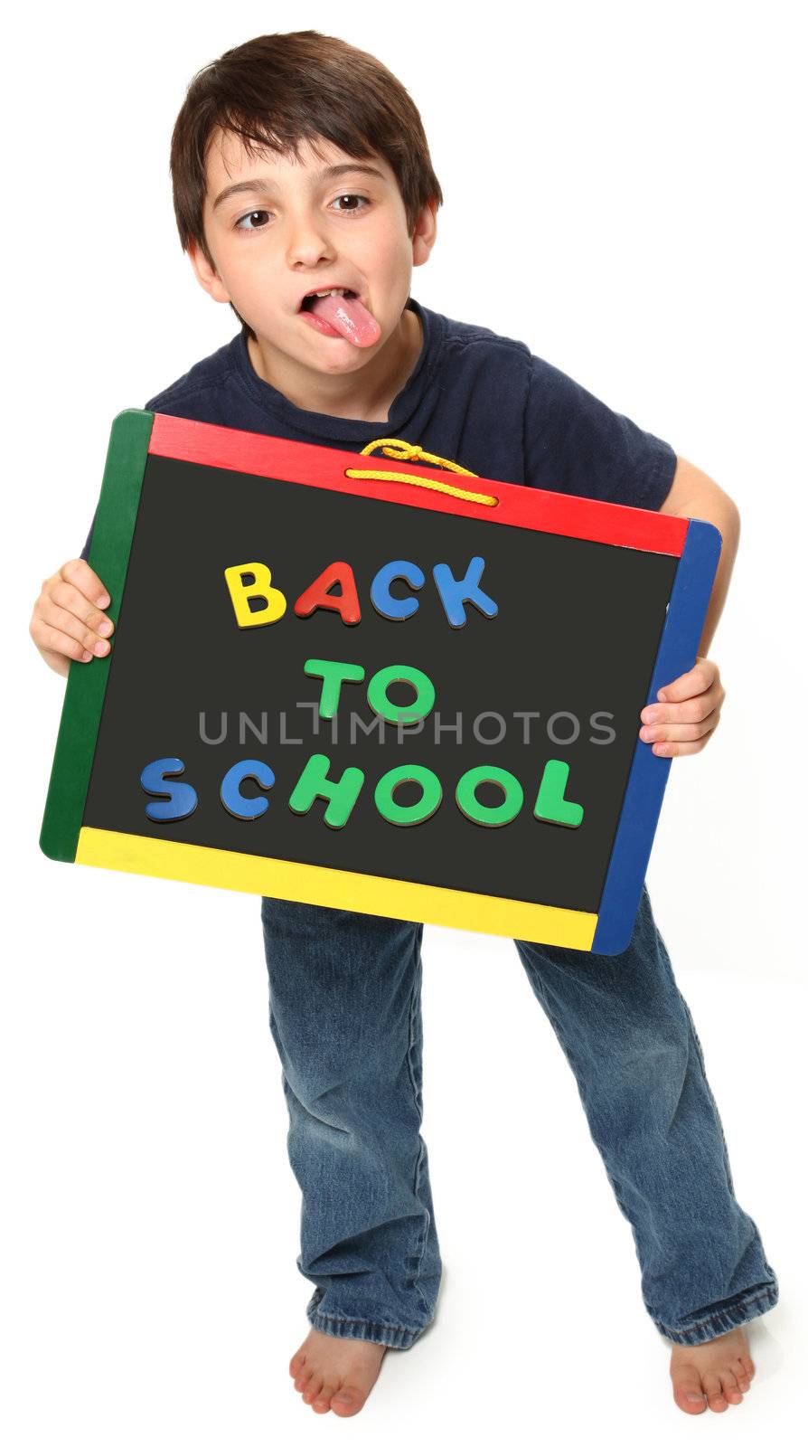 adorable seven year old boy holding back to school magnetic chalk board