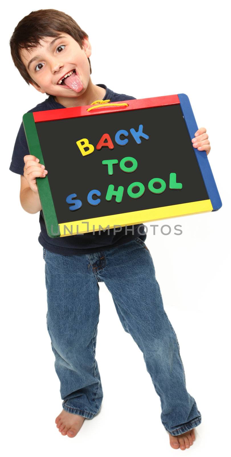 adorable seven year old boy holding back to school magnetic chalk board making silly faces