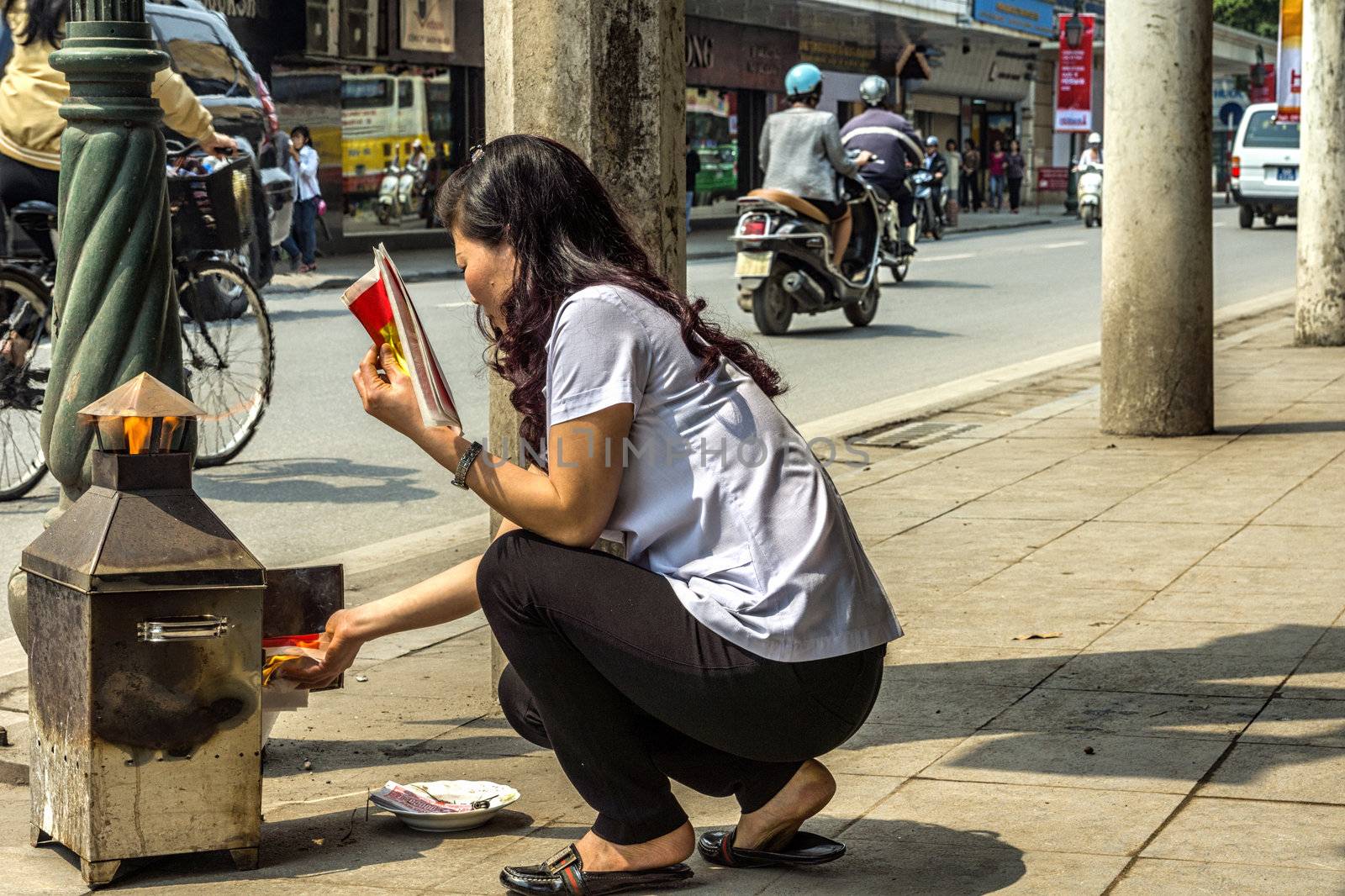 Vietnam Hanoi - March 2012: Burning fake money by Claudine