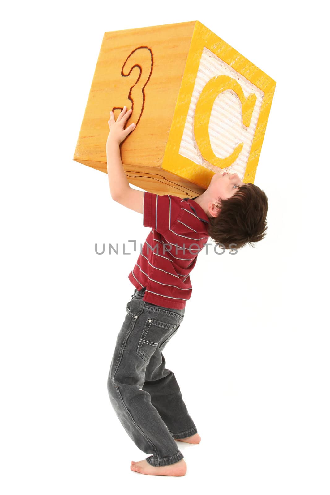 Boy holding a large letter C alphabet block over white.