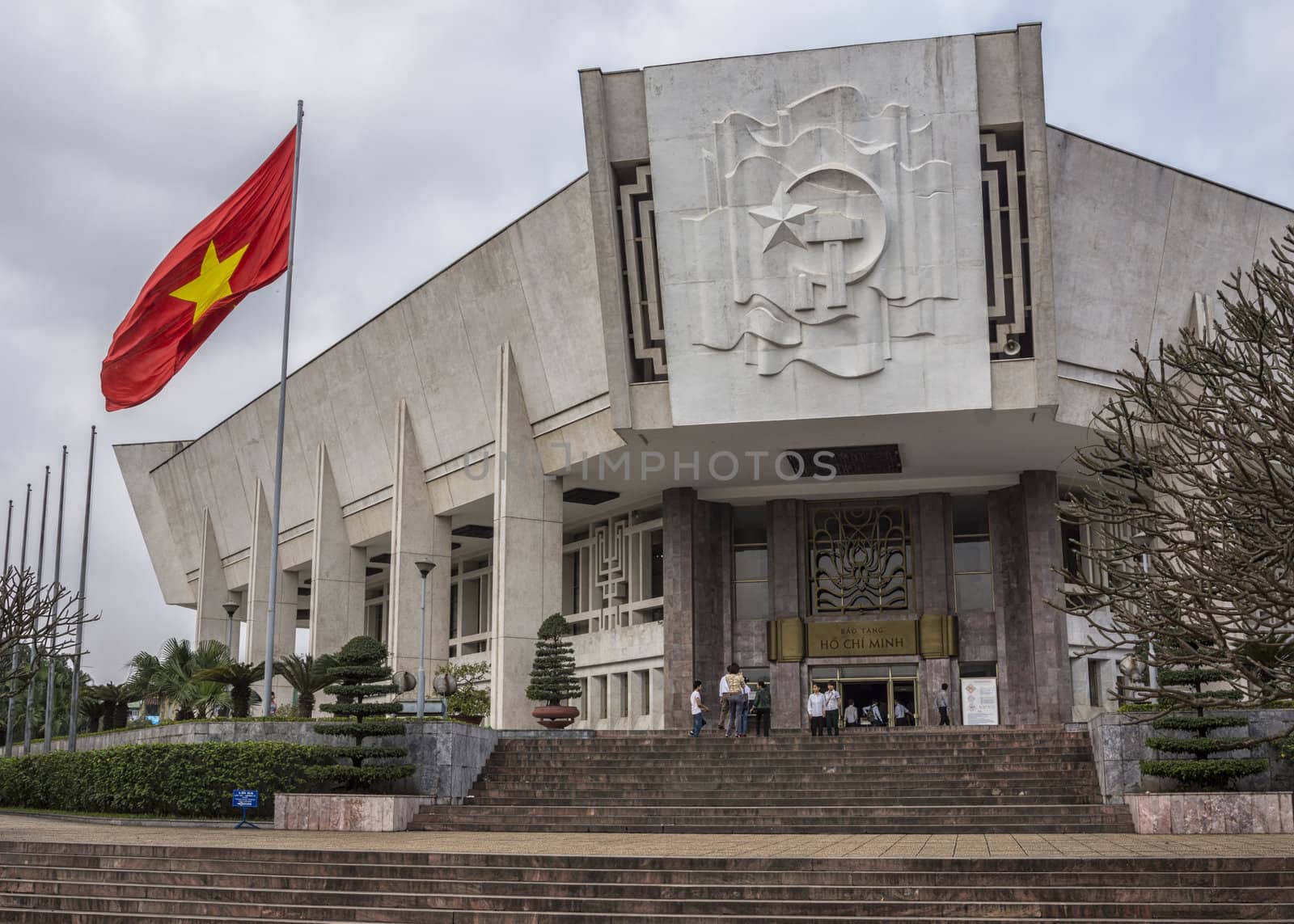 Hammer and sickle plus national flag decorate modern building.