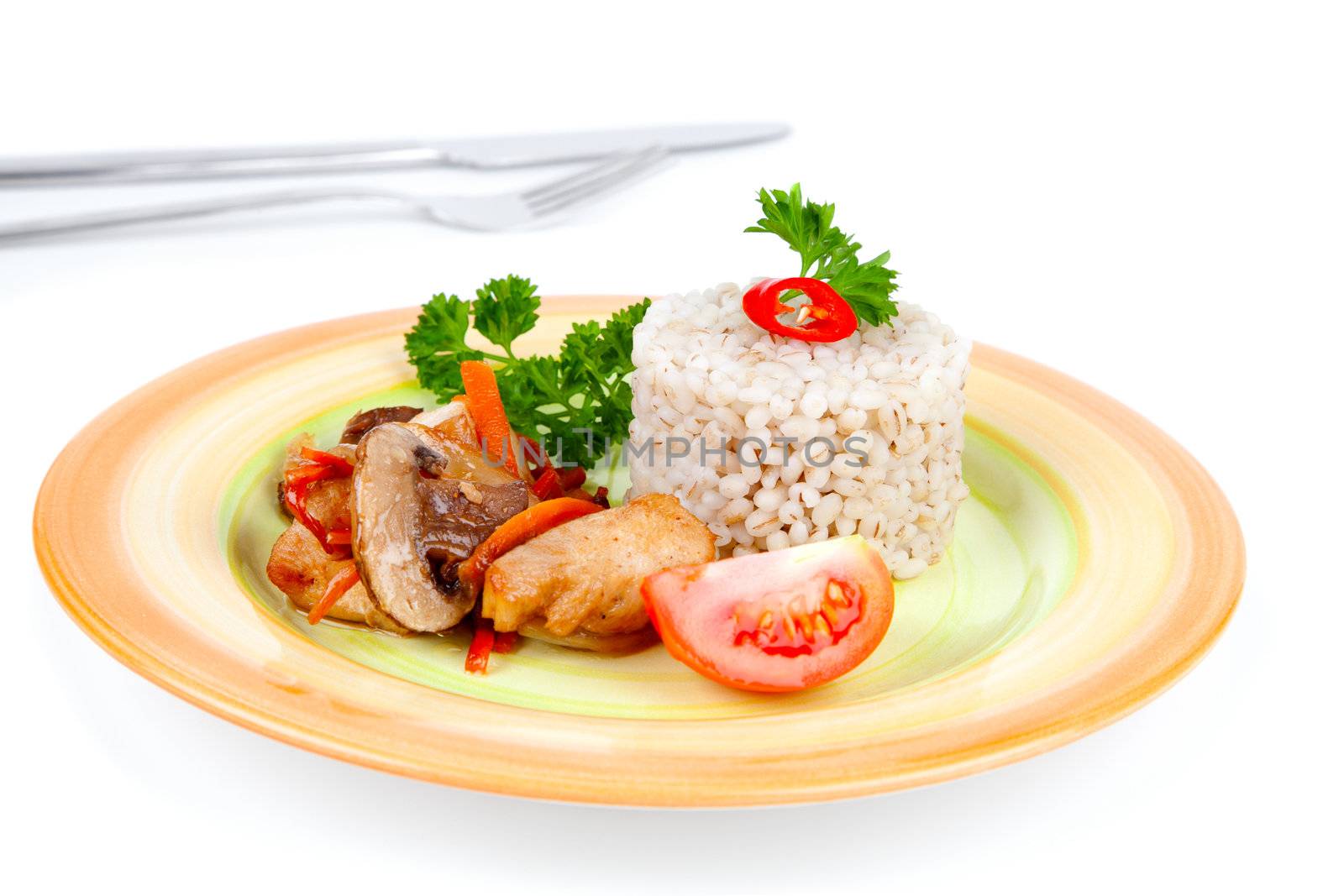 Fried mushrooms with chicken and vegetables, served with pearl barley