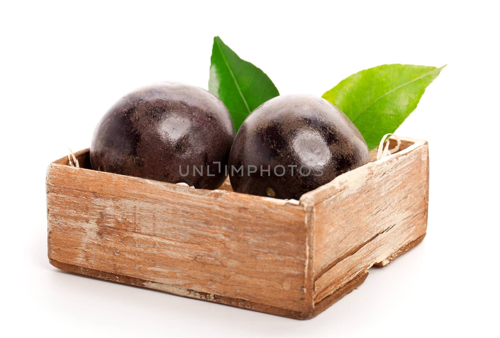 Fresh passion fruit in the old box, isolated on a white background