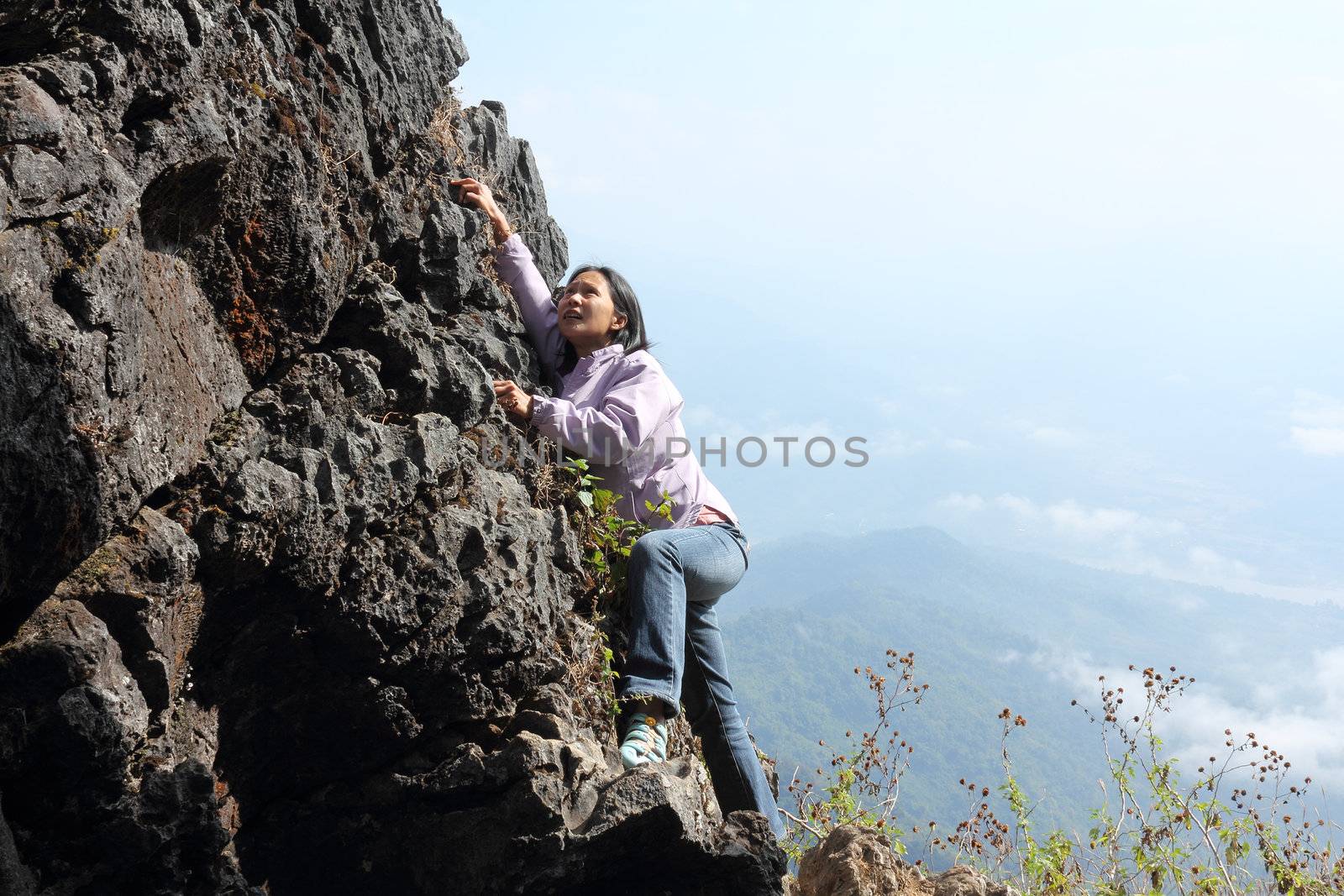 Thai woman climbing rock