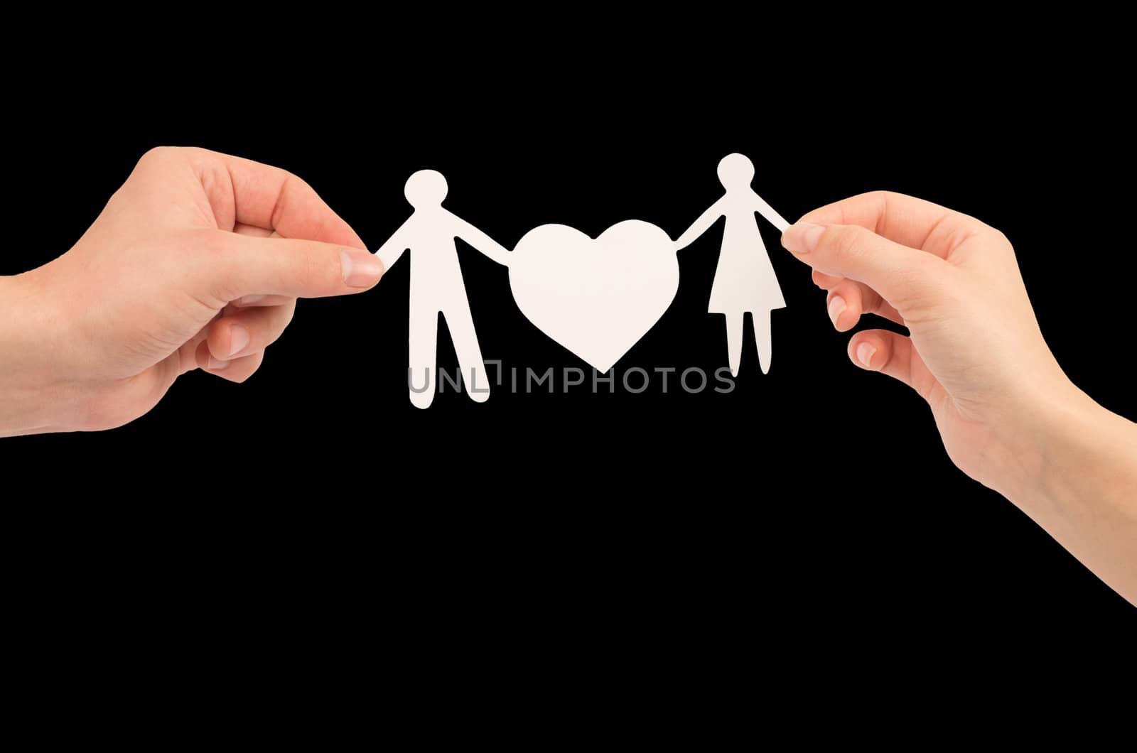 paper family in hands isolated on black background